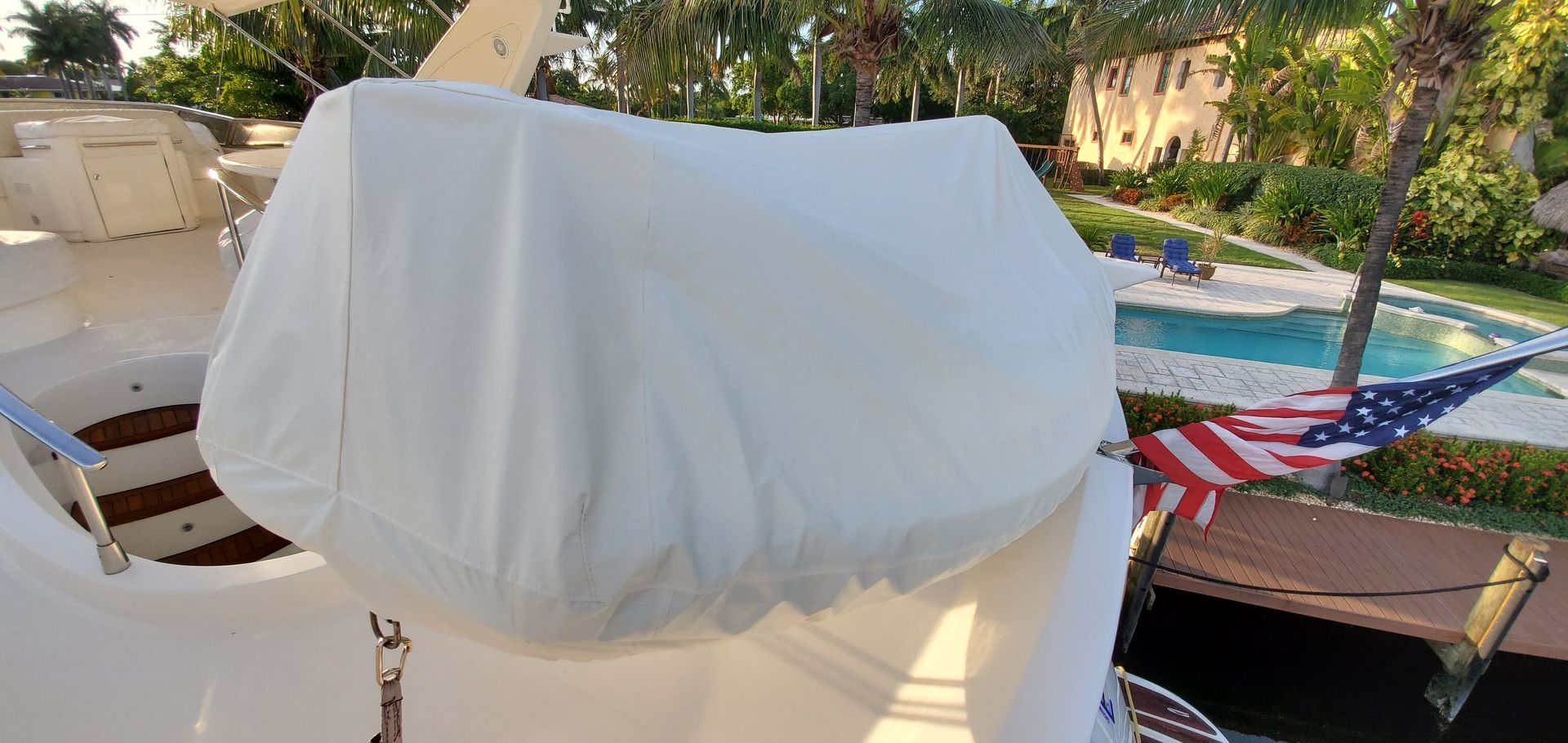 A white seat cover on a boat with an american flag in the background.
