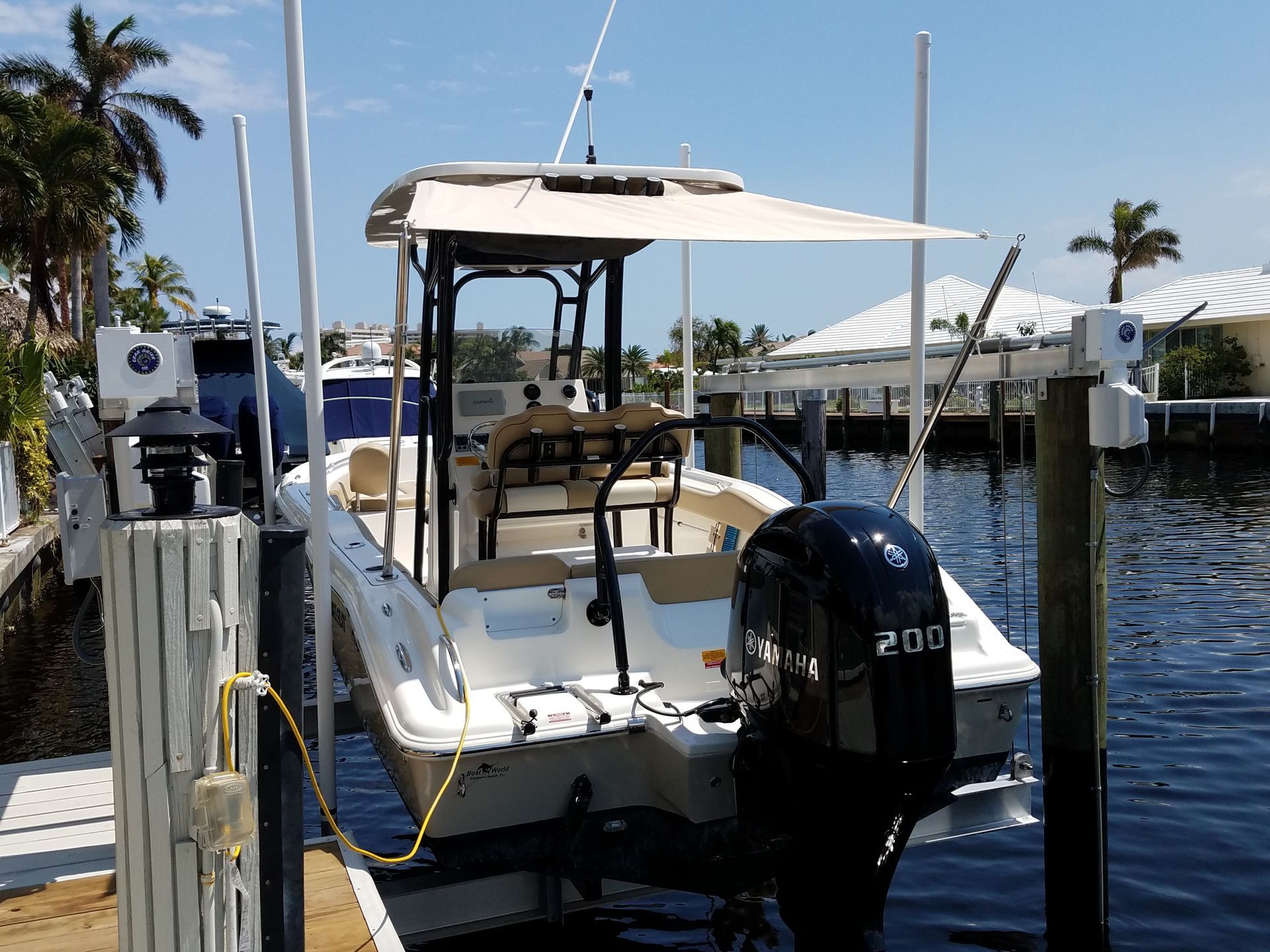 A boat with a 200 outboard motor is docked at a dock