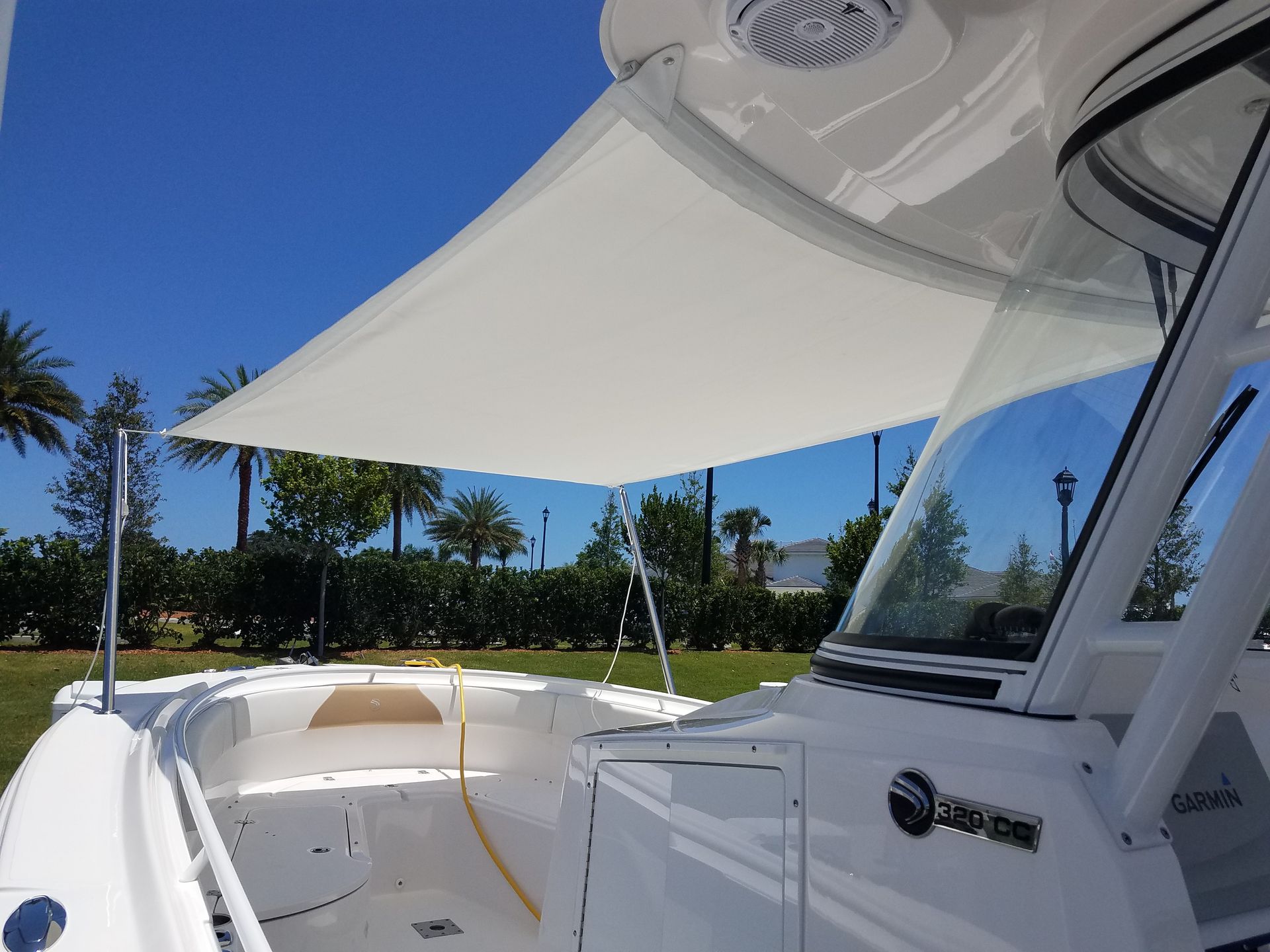 A white boat with a white canopy on top of it
