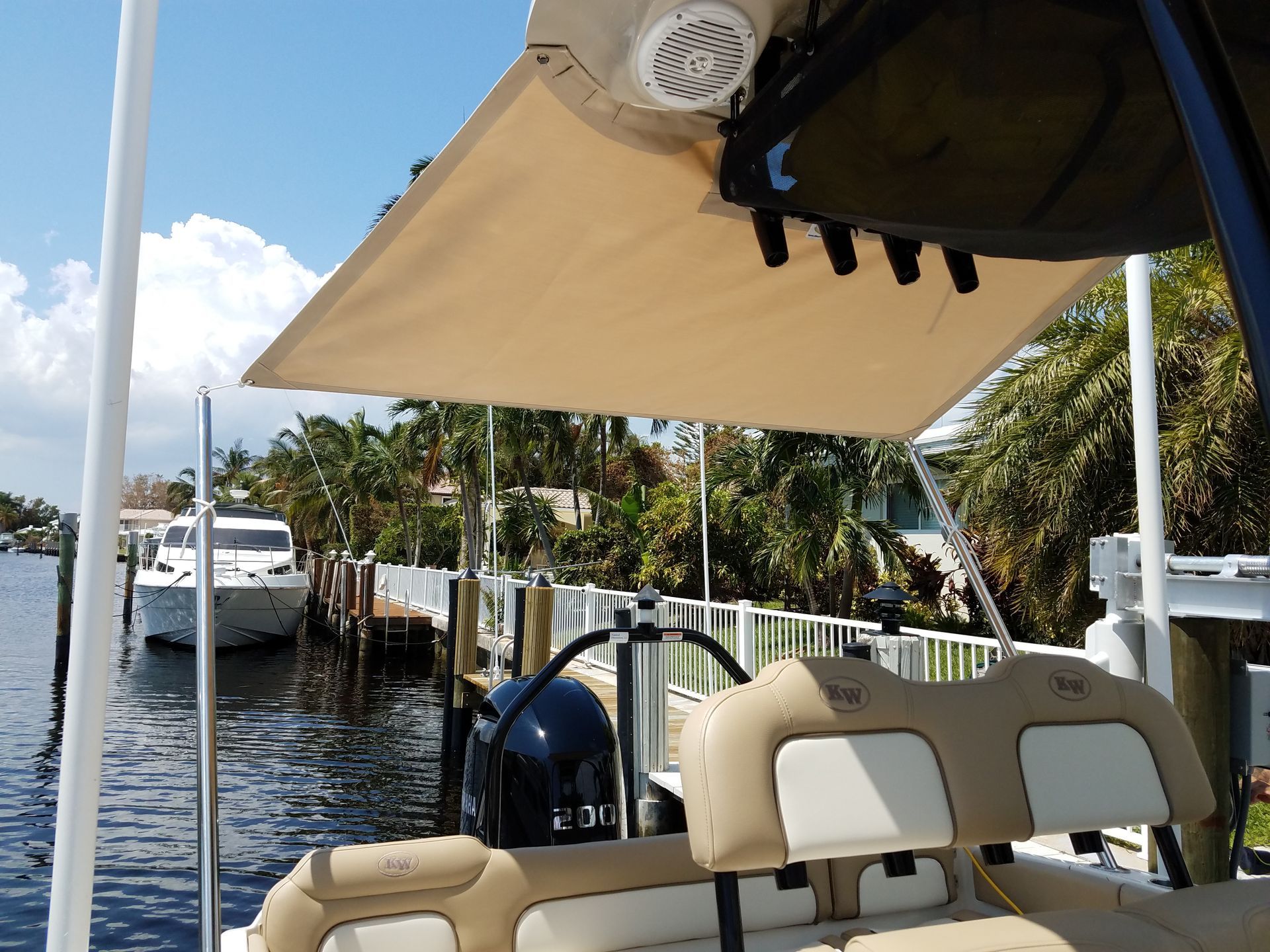 A boat is docked at a dock with a boat in the background