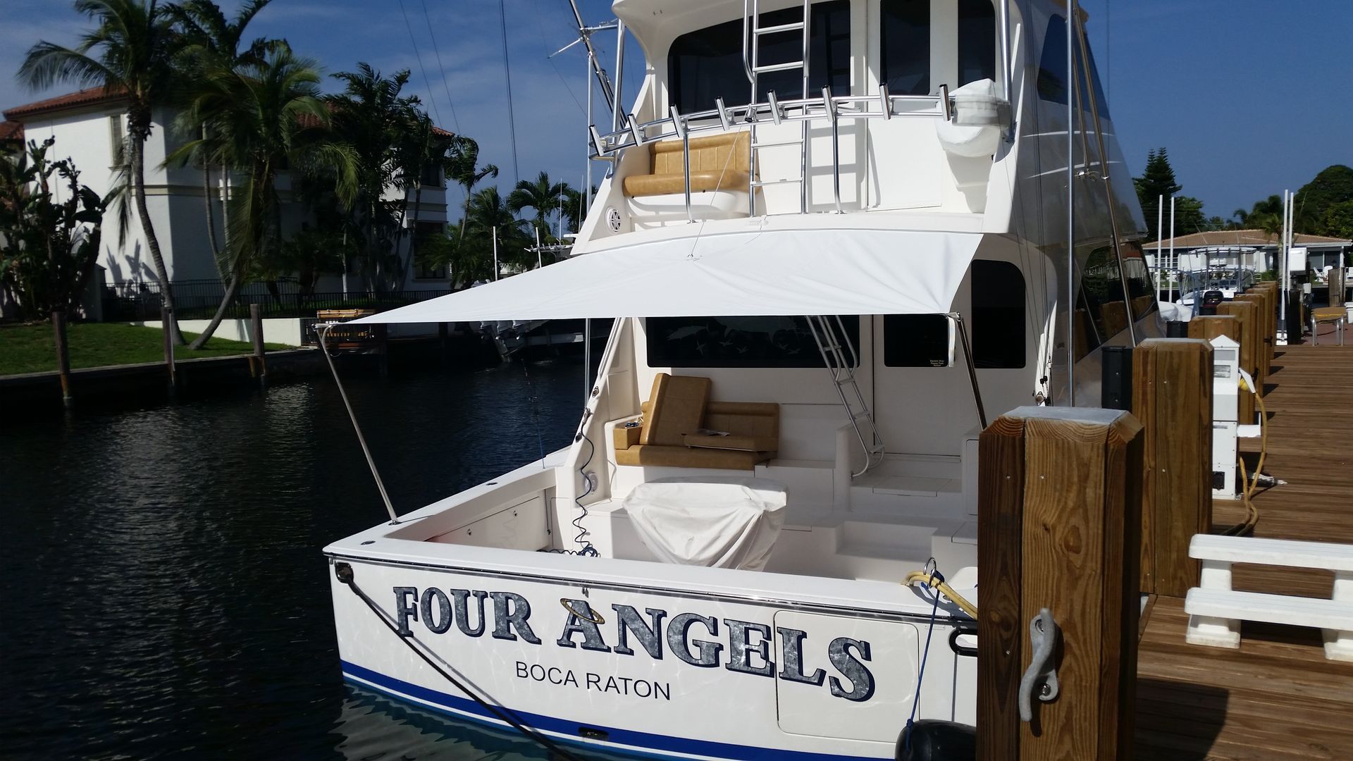 A boat named four angels is docked at a dock