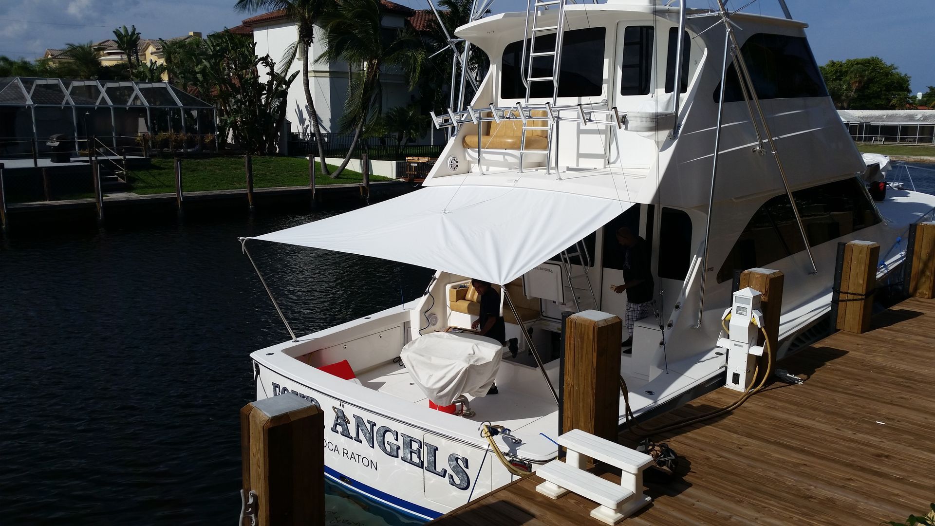 A boat named angels is docked at a dock