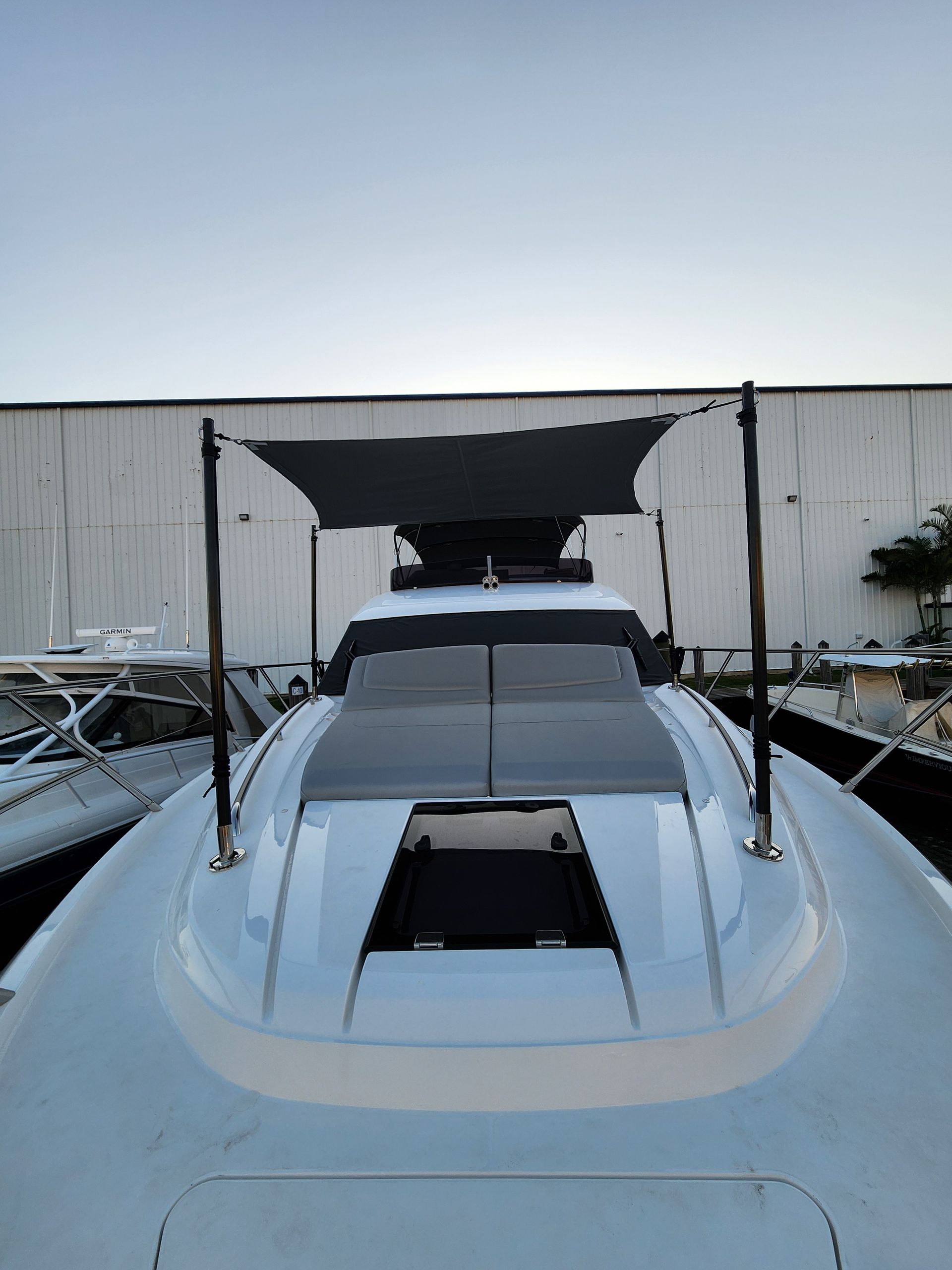 A boat with a canopy on top of it is docked in front of a building.