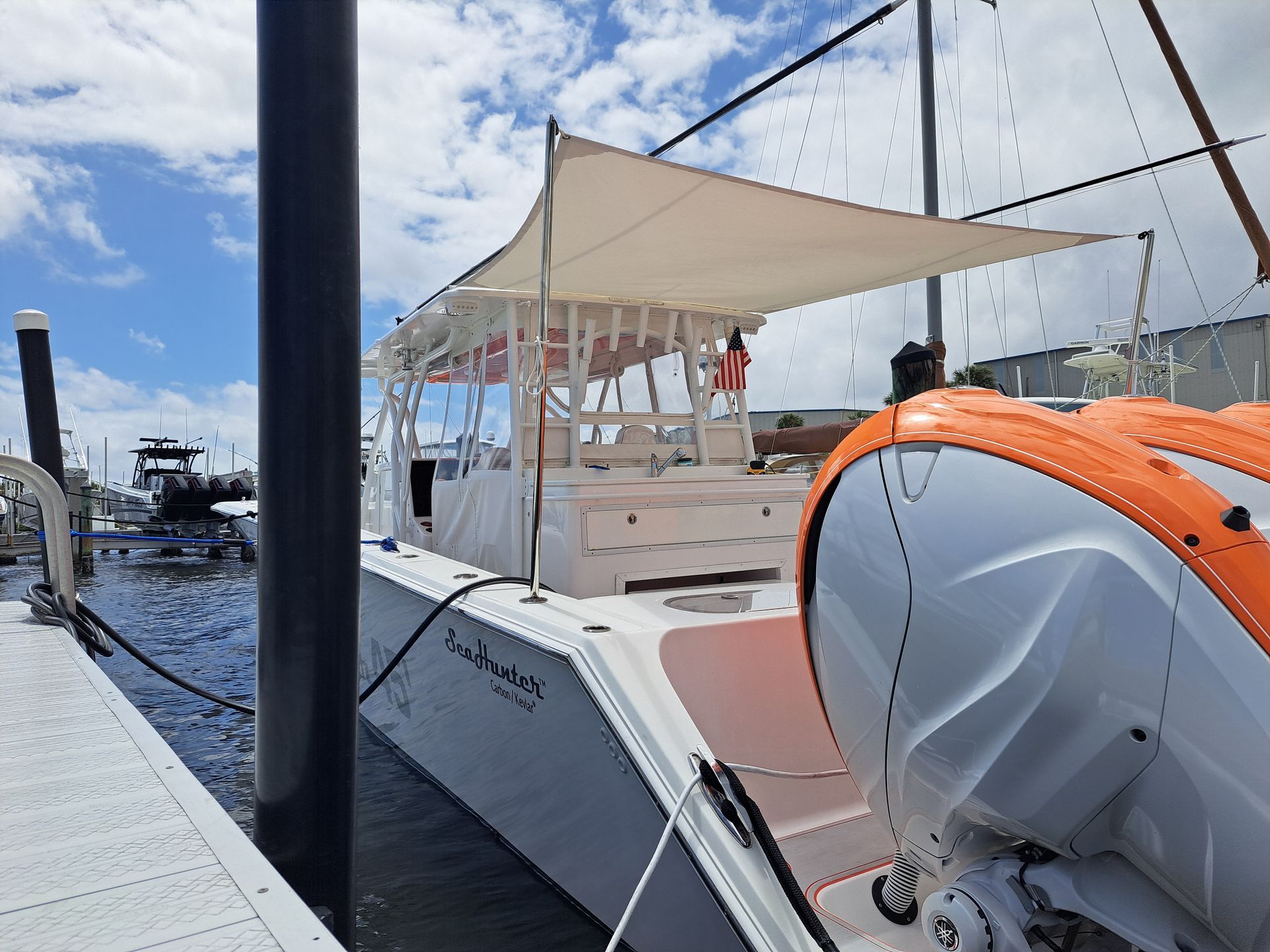 A boat is docked at a dock with a canopy over it