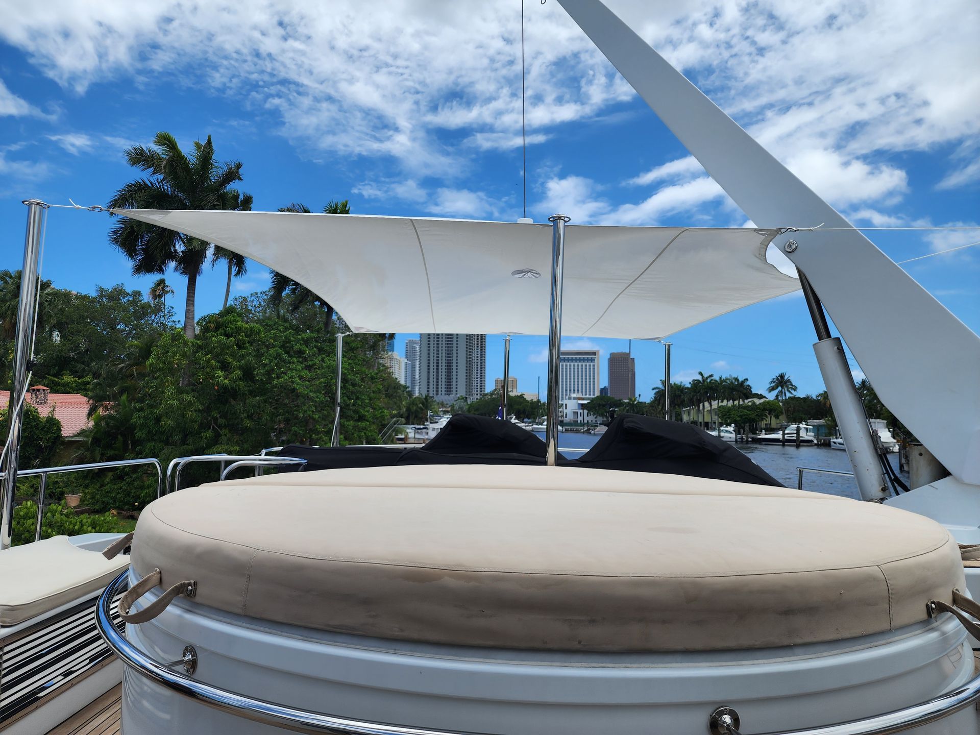 A boat with a round bed under a white umbrella