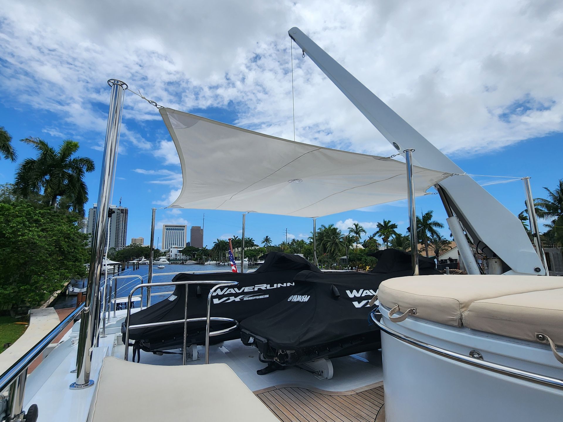 A boat with a jet ski under a white umbrella