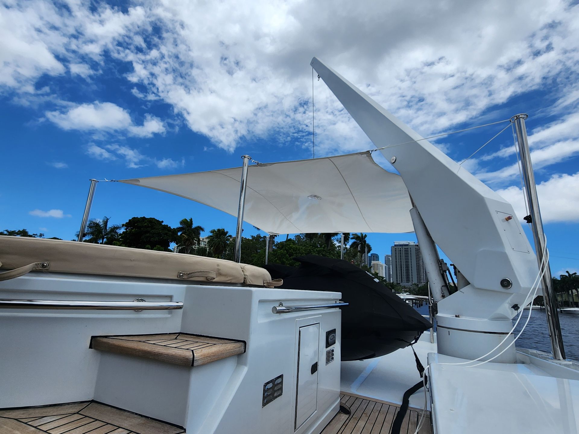 A white boat with a sail on top of it.
