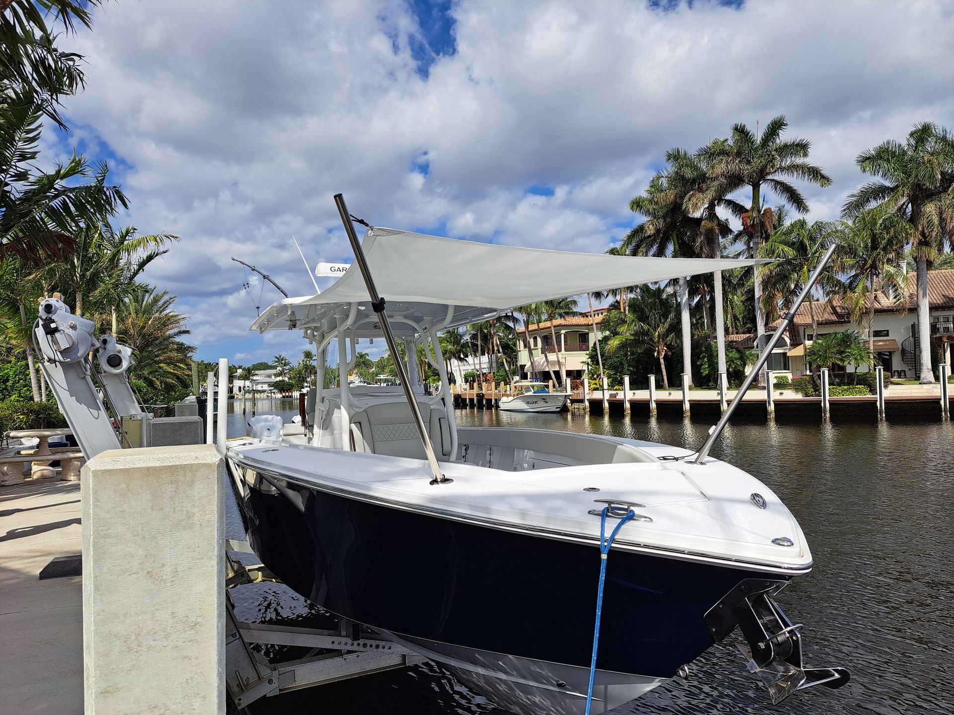 A boat is docked at a dock with a canopy on top of it.