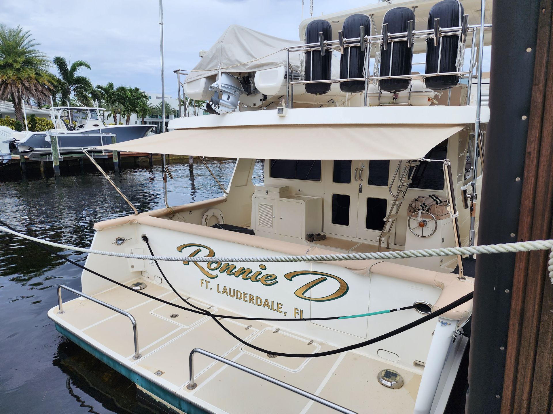 A boat named rosie d is docked in a marina