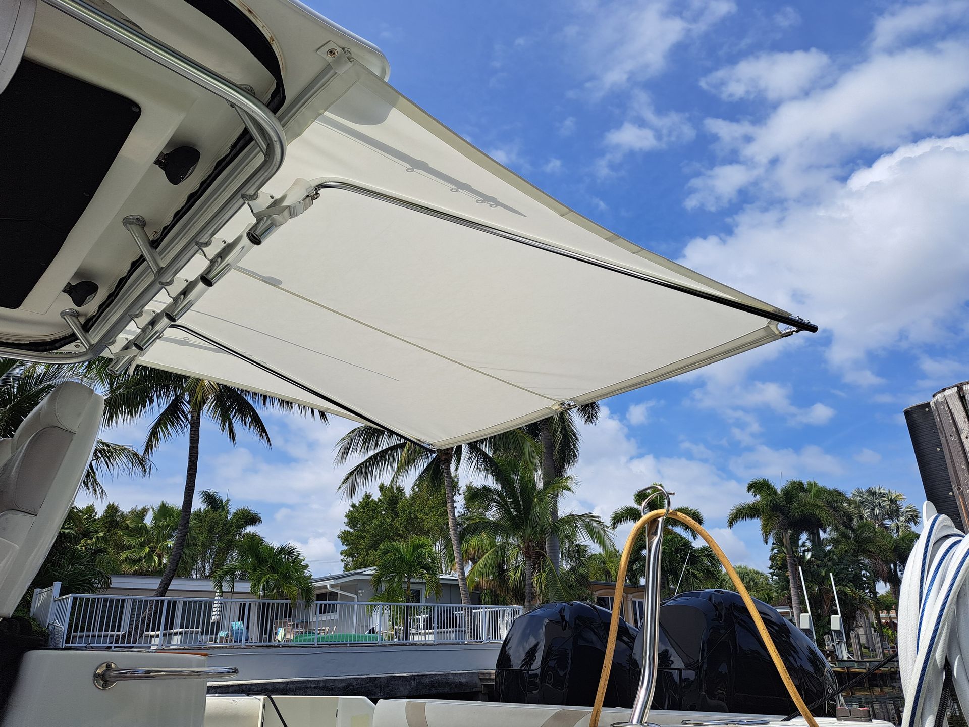 A boat with a canopy on top of it and palm trees in the background