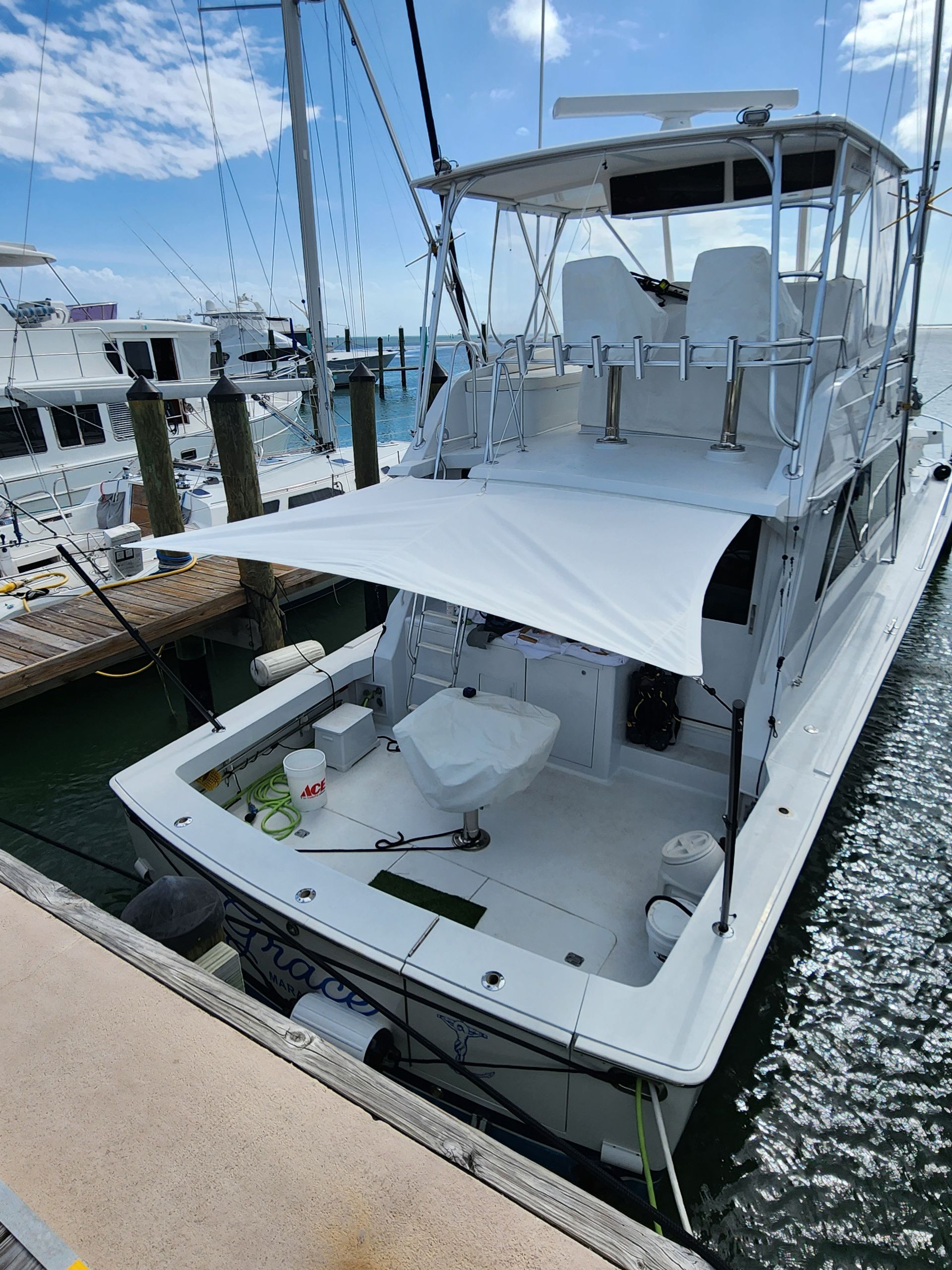 A large white boat is docked at a dock.