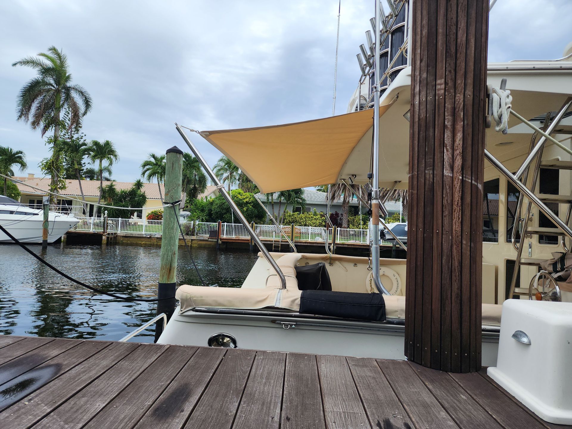 A boat is docked at a dock with a sail on top of it