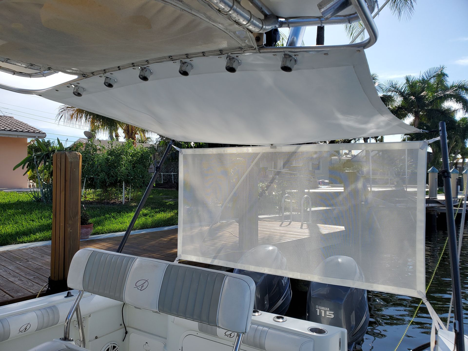 A boat with a canopy on top of it is docked at a dock.