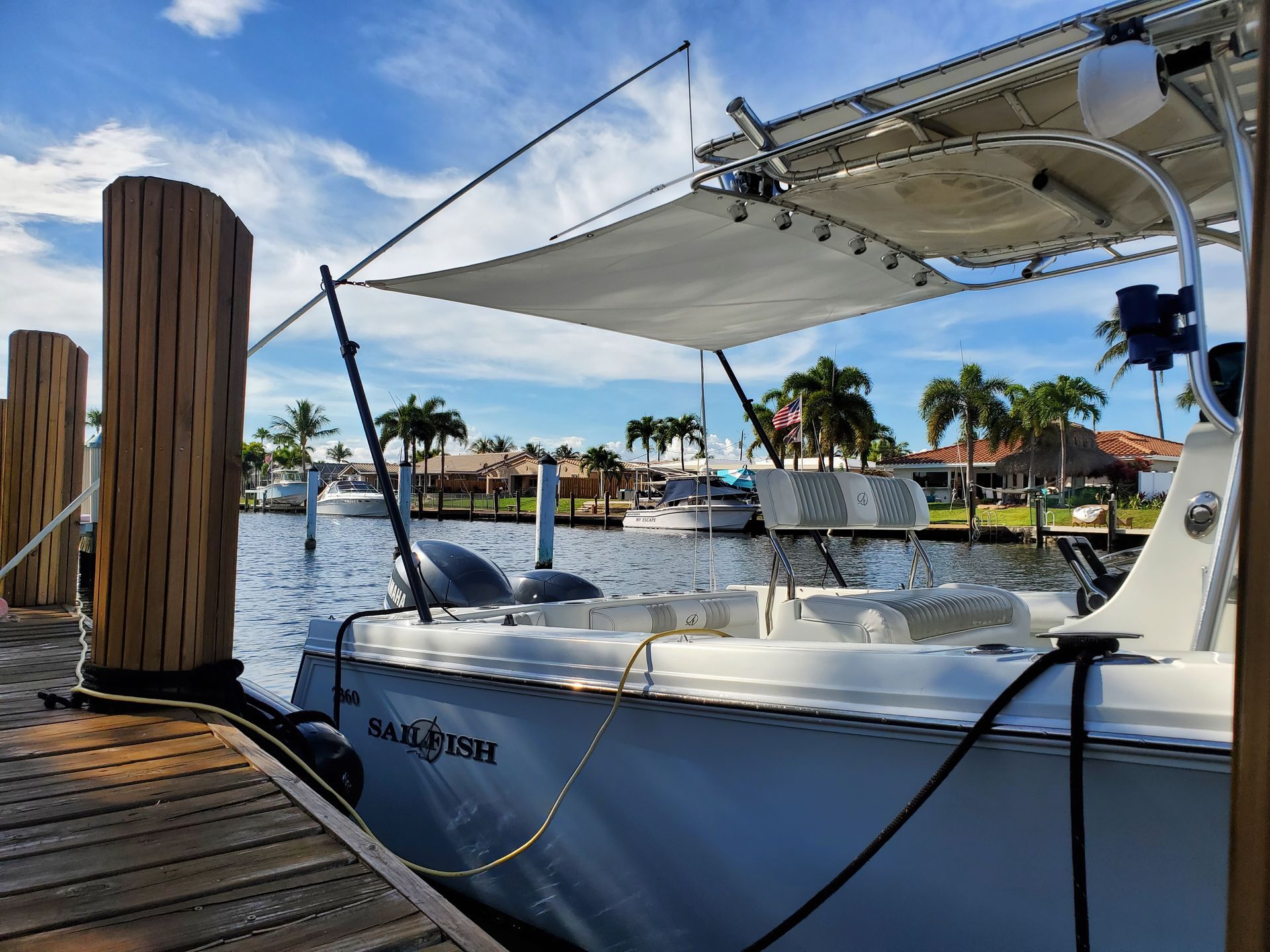 A boat with a canopy is docked at a dock.