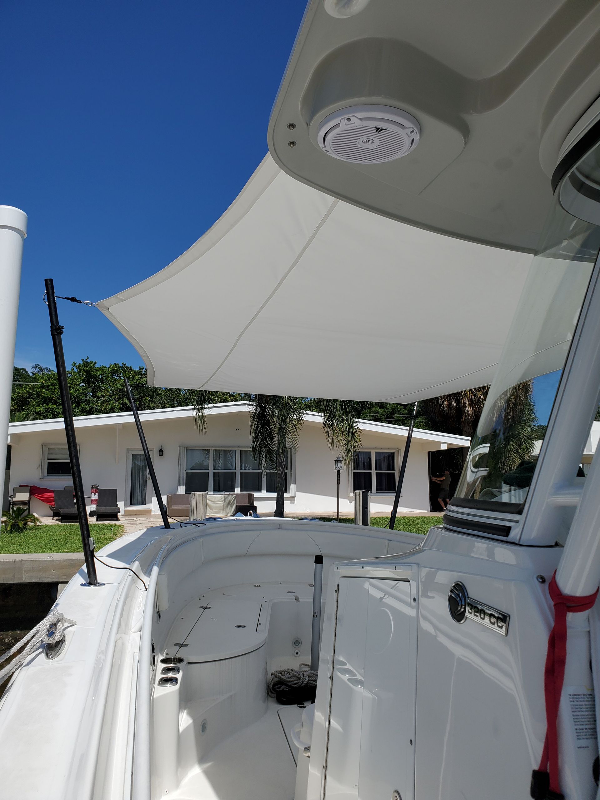 A white boat with a white sail on top of it