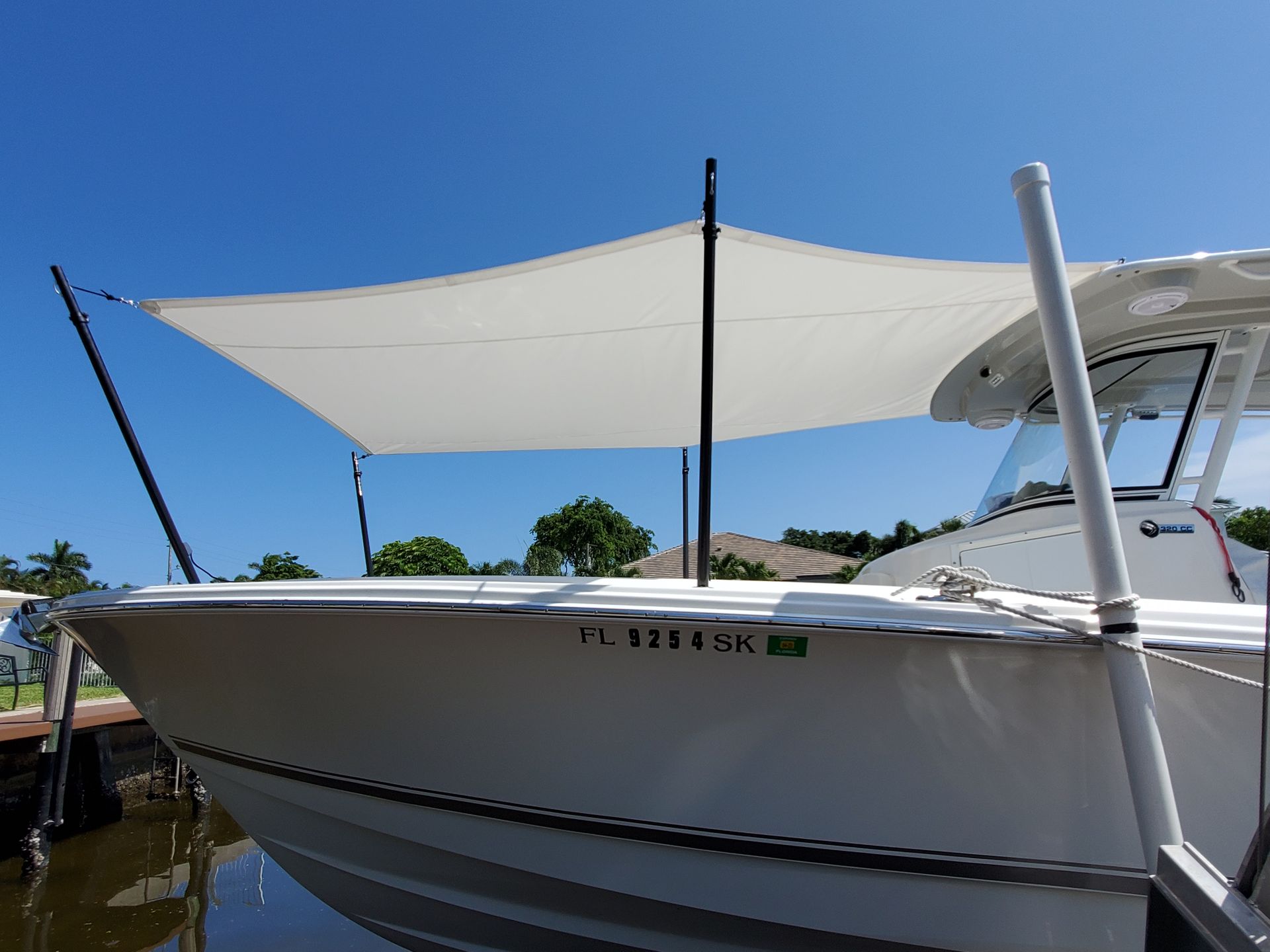 A white boat with a white sail on top of it