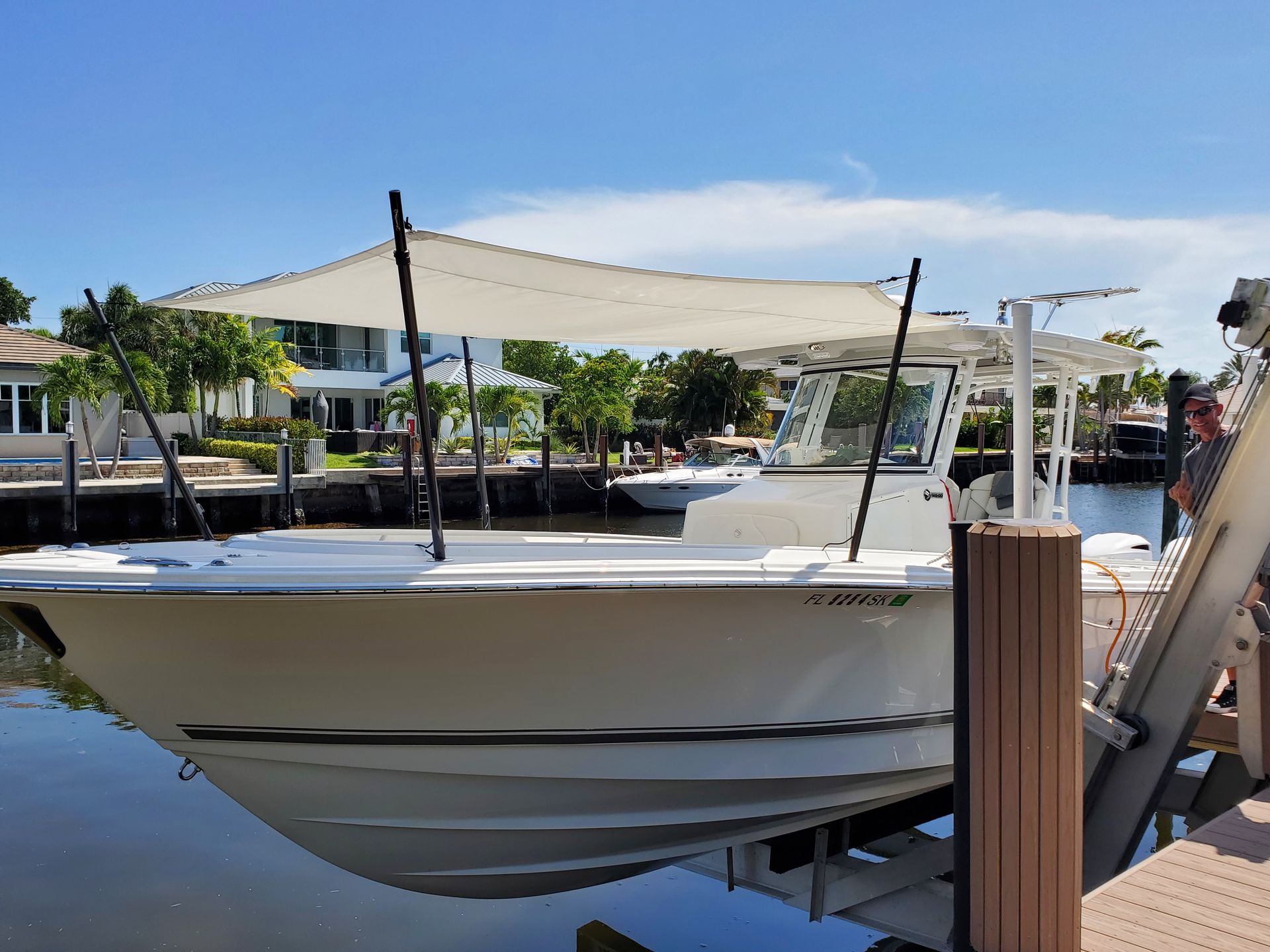 A boat is docked at a dock with a canopy over it.