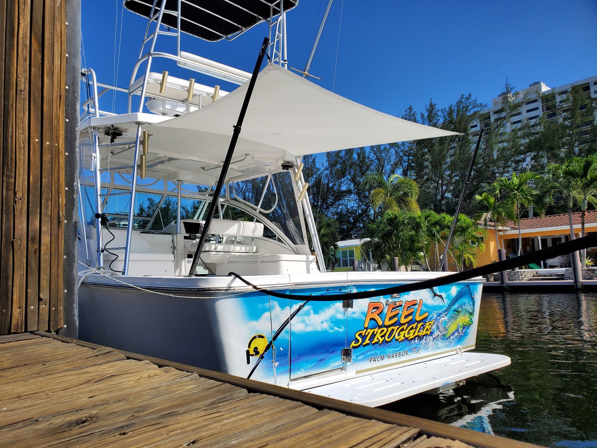 A boat is docked at a dock next to a body of water.