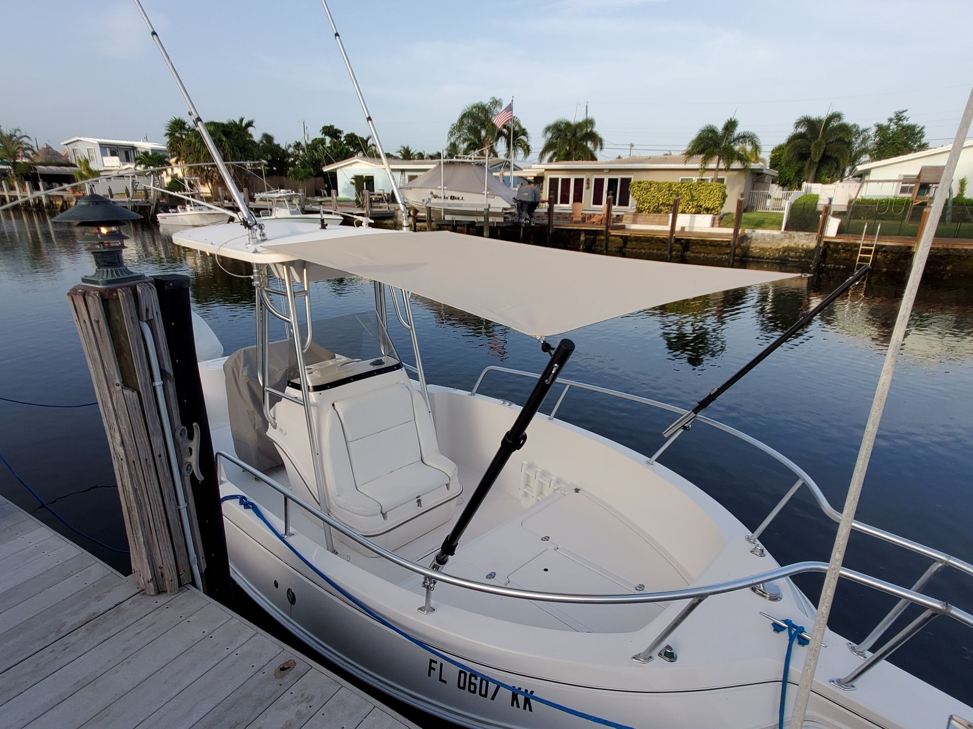 A boat with a canopy is docked at a dock