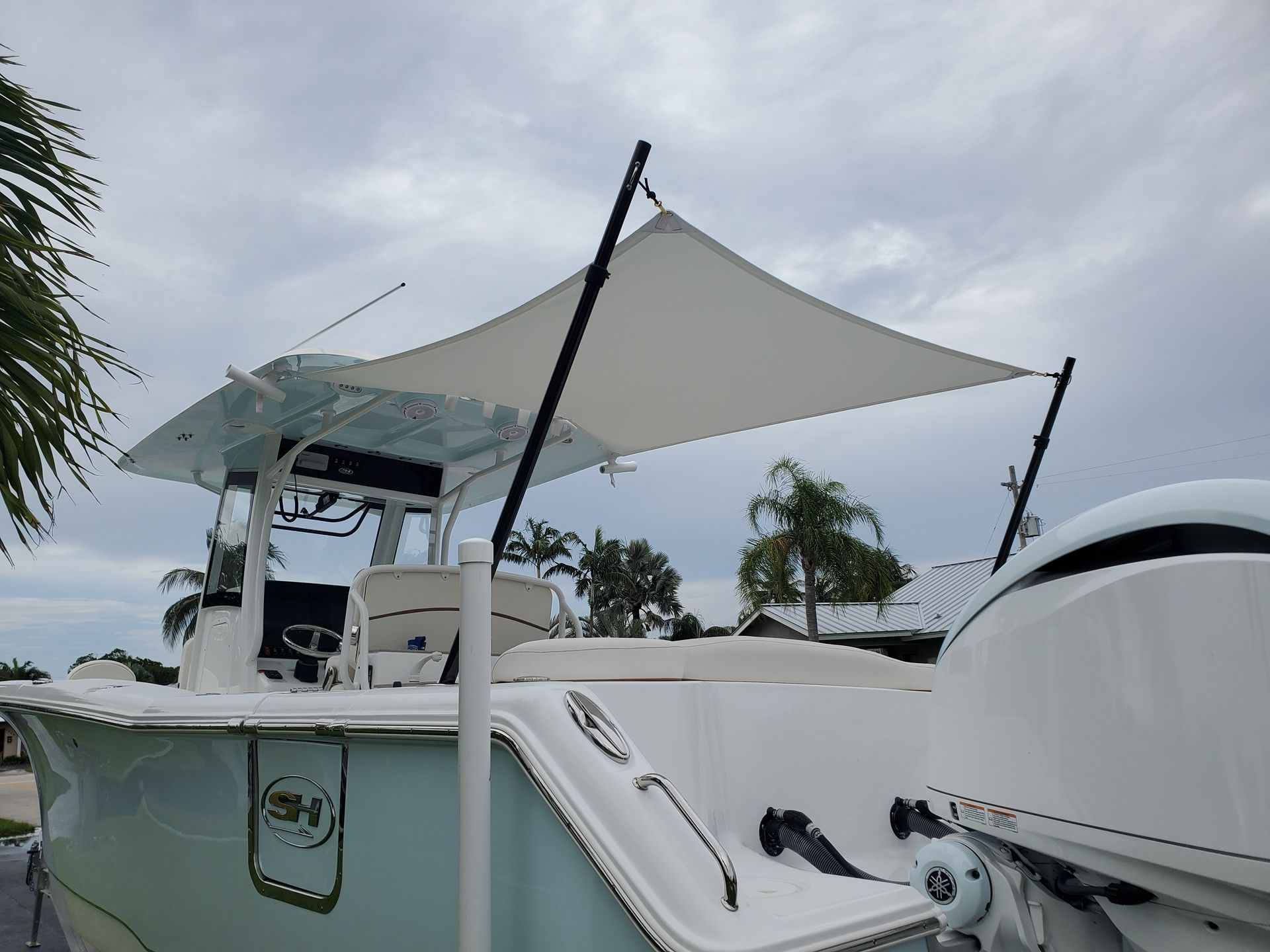 A white boat with a white umbrella on top of it.