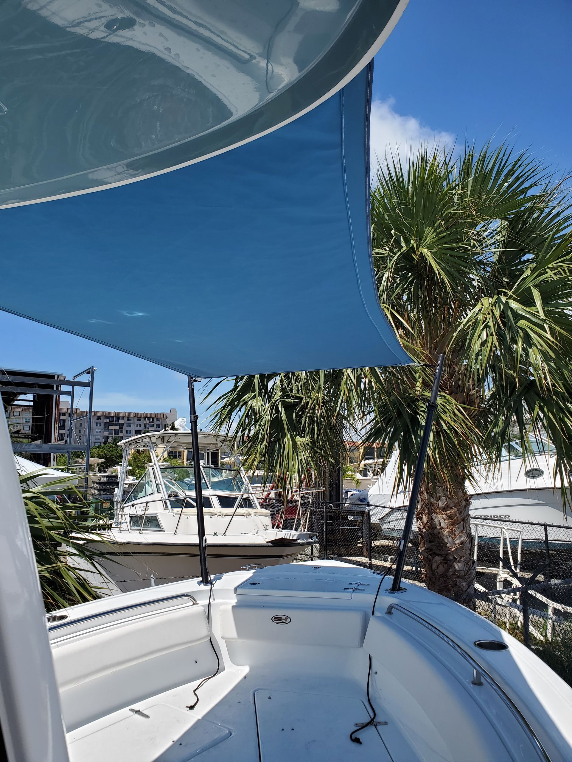 A boat with a blue umbrella on top of it