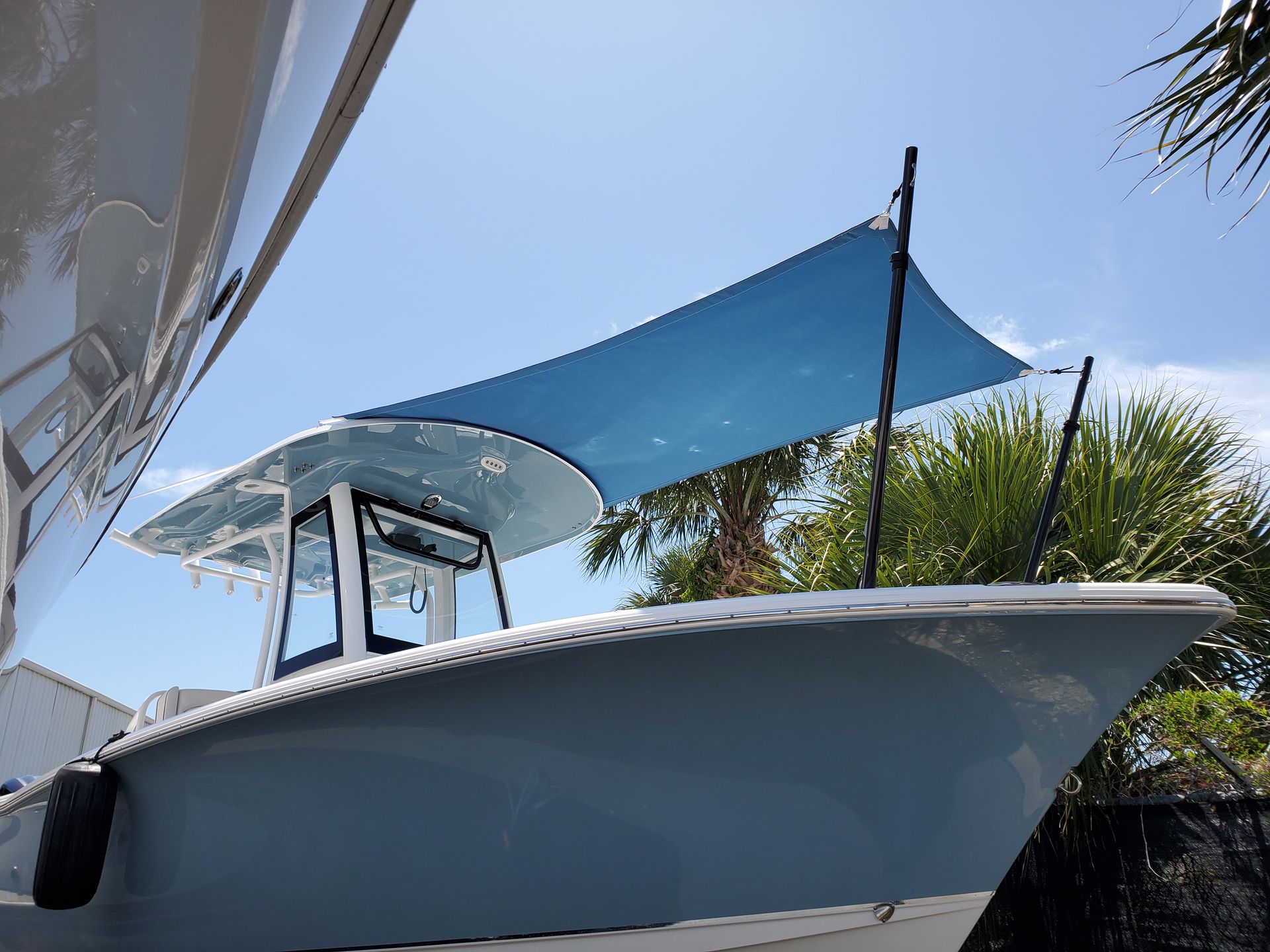 A boat with a blue sail on top of it.