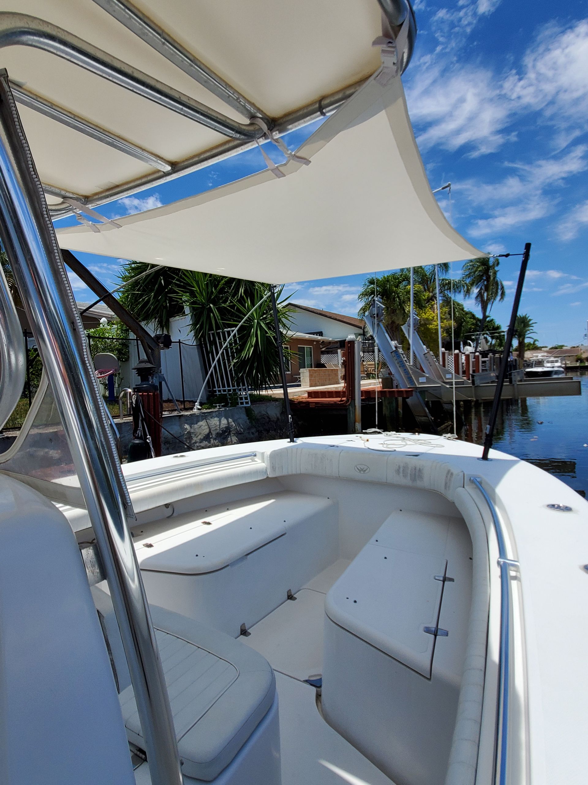 A white boat with a canopy on top of it