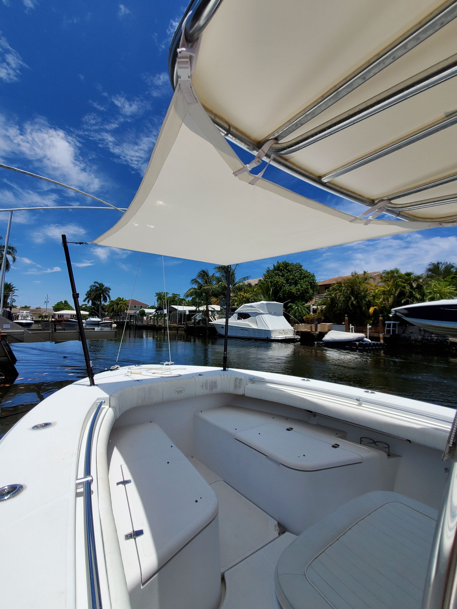 A white boat with a white umbrella on top of it