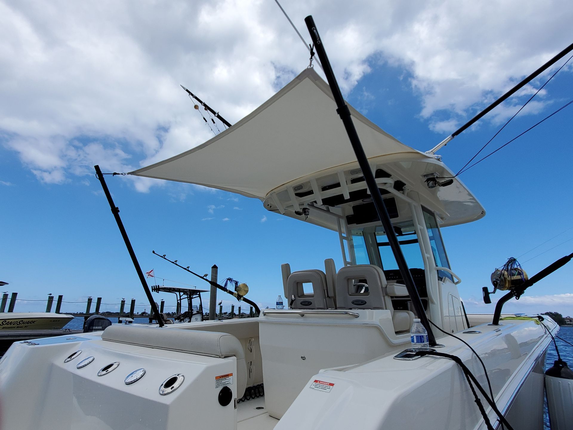 A white boat with a sail on top of it