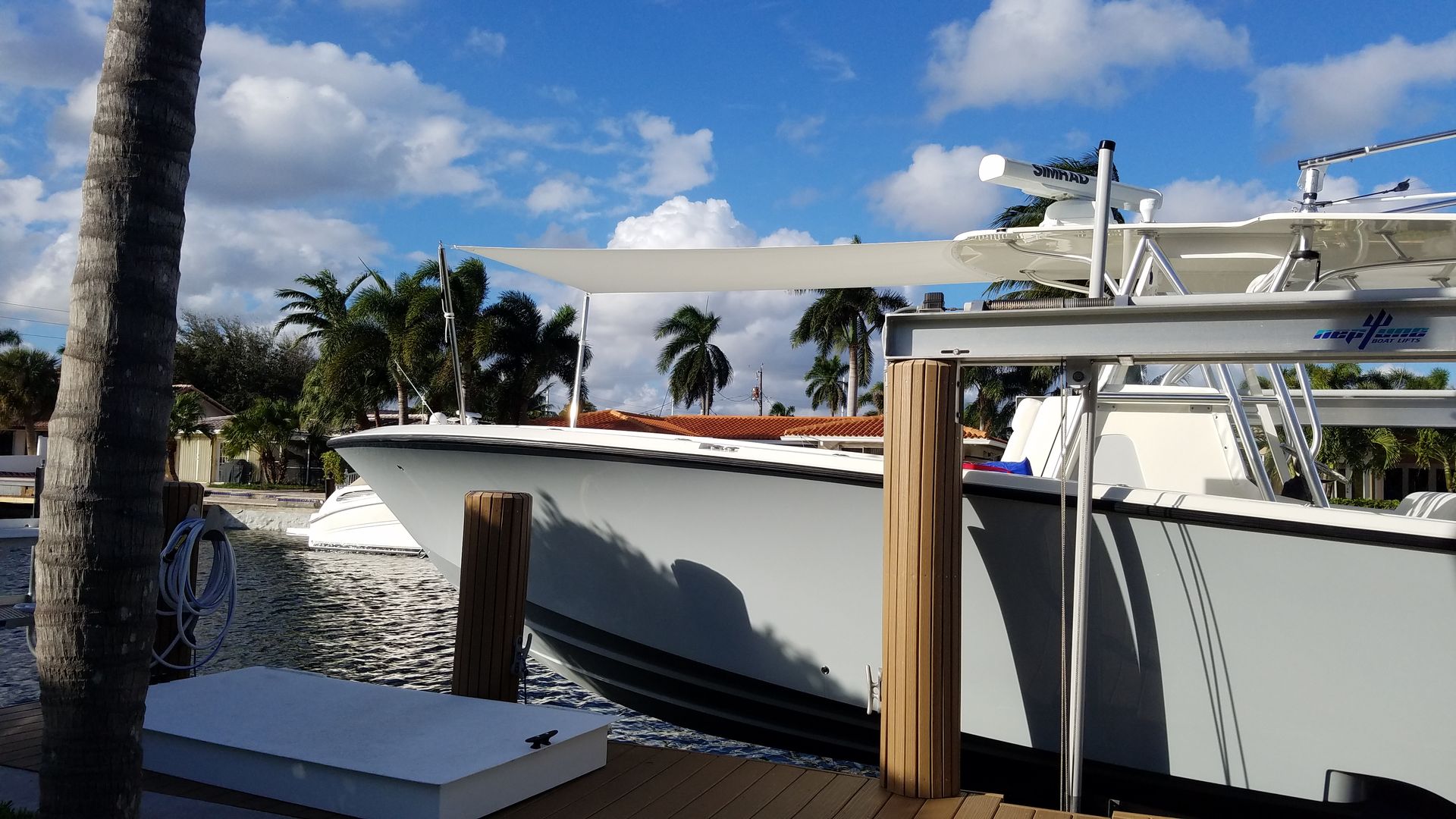 A boat is docked at a dock on a sunny day
