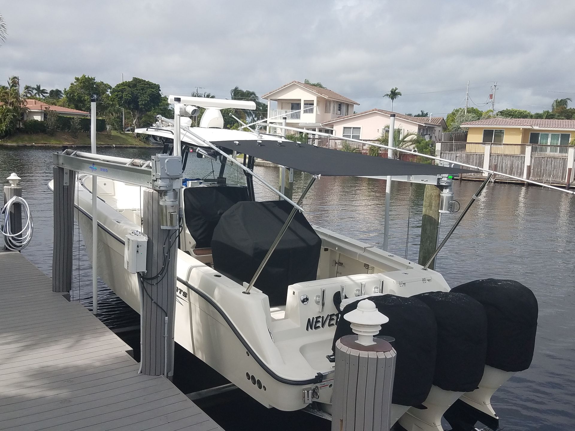 A boat named neves is docked at a dock