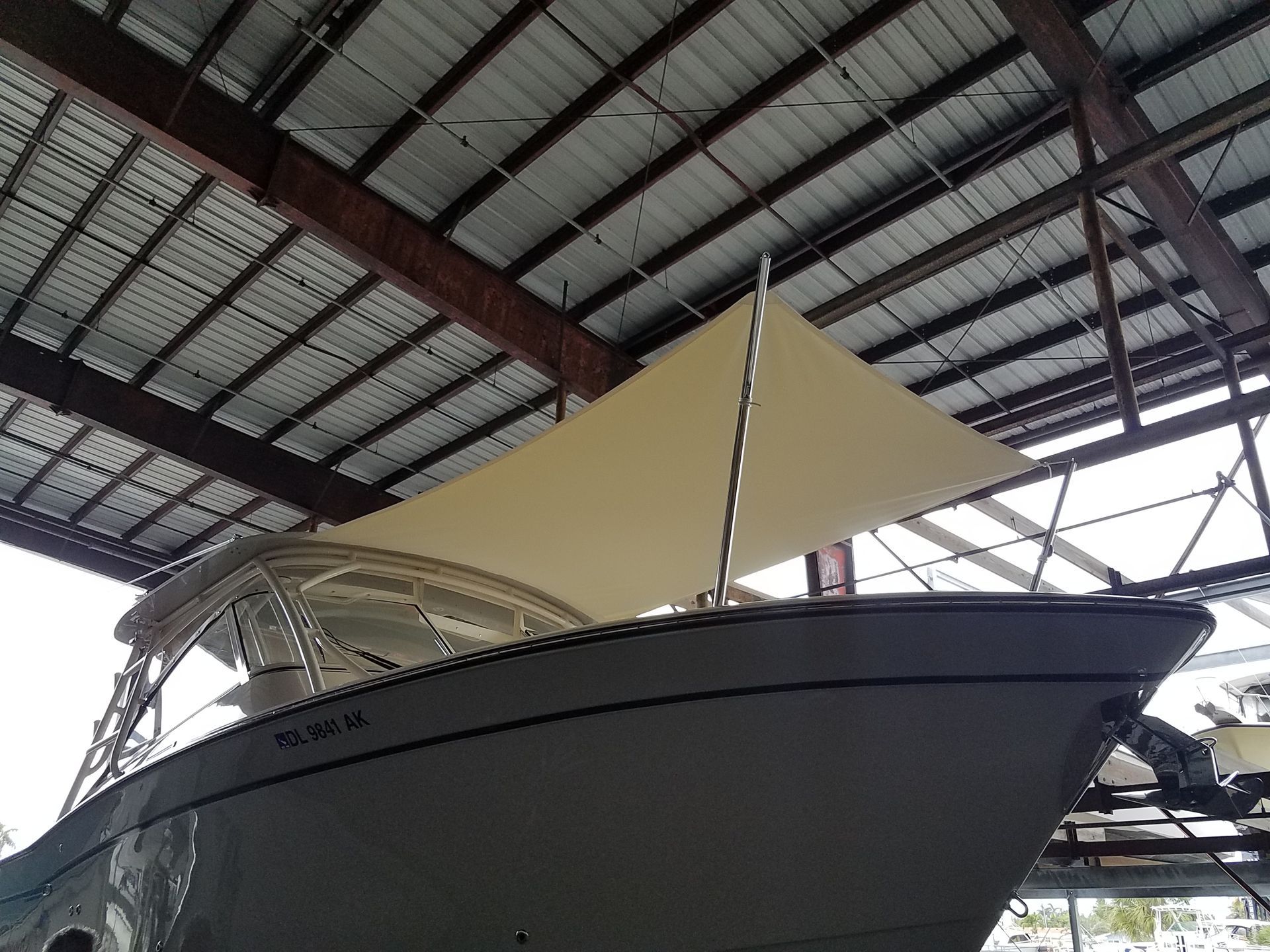 A boat with a sail hanging from the ceiling
