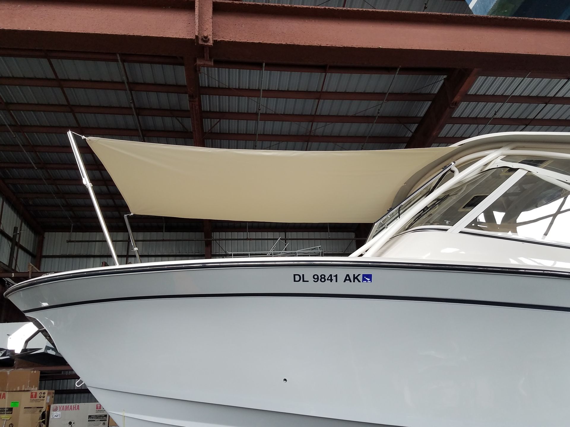 A white boat with a license plate that says dl504 akm