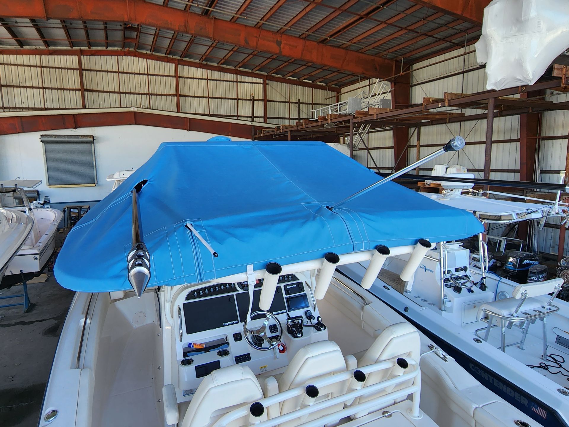 A boat with a blue cover on top of it
