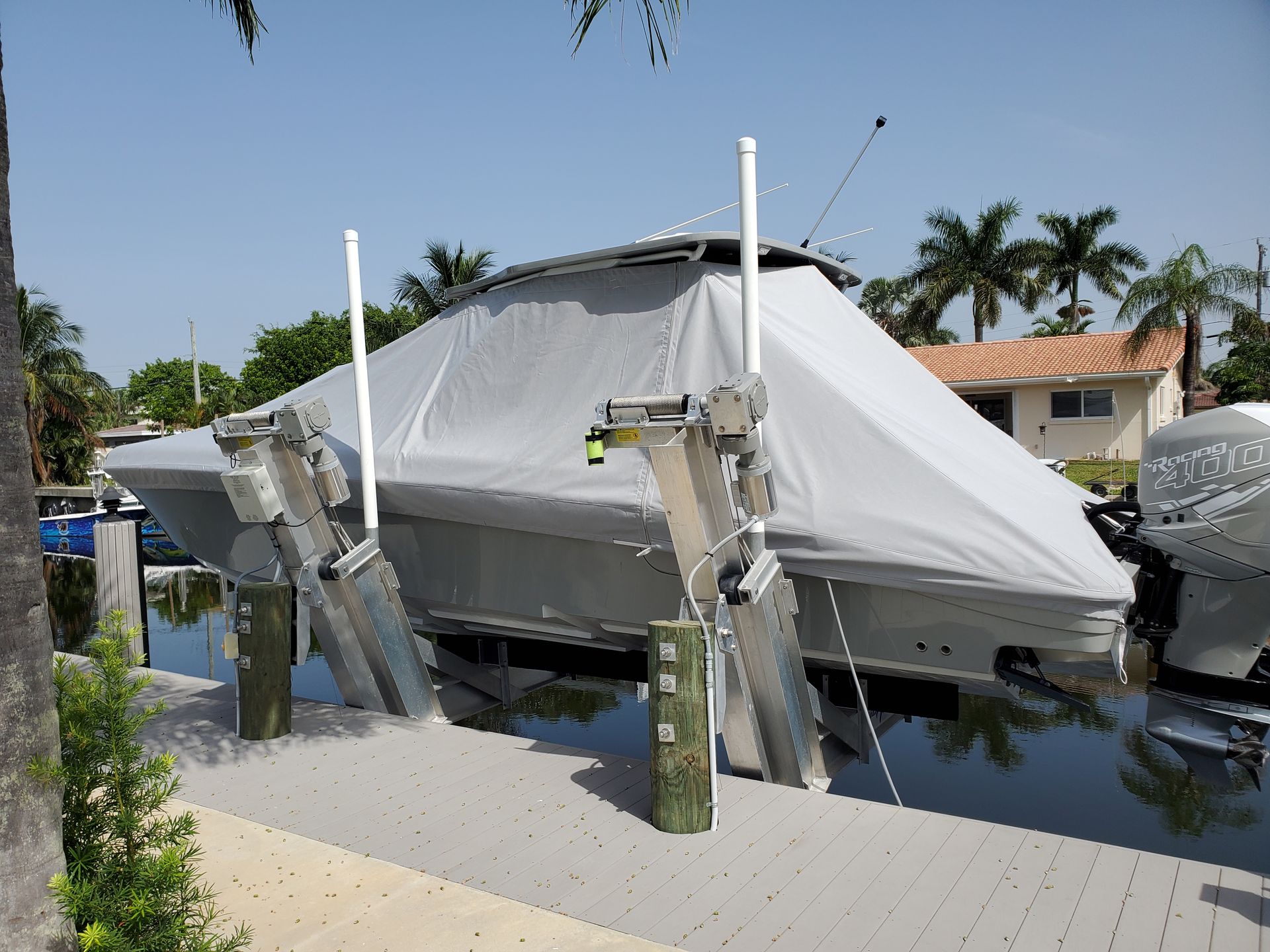 A boat is sitting on a dock with a cover on it