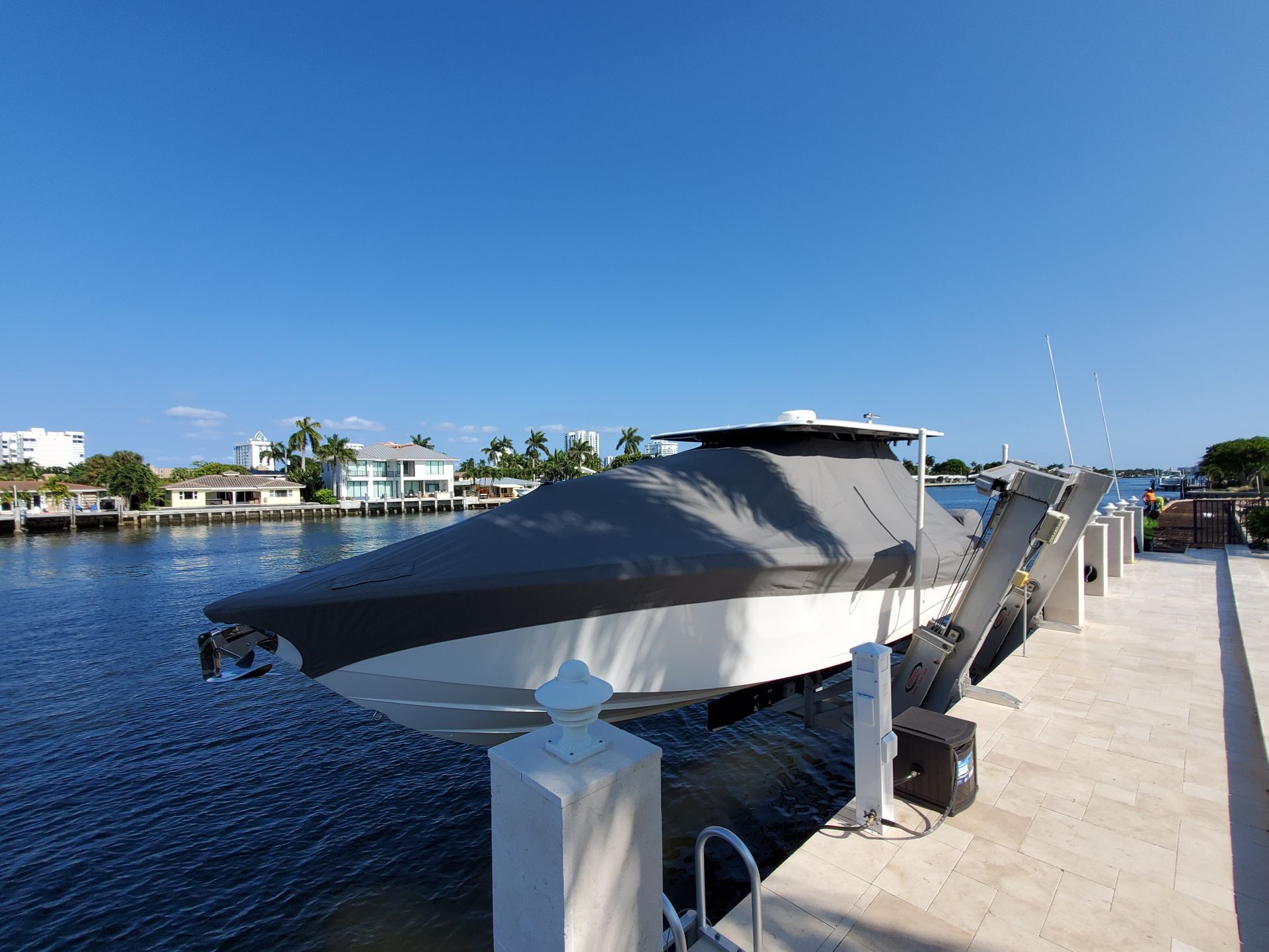 A boat is docked at a dock with a cover on it.