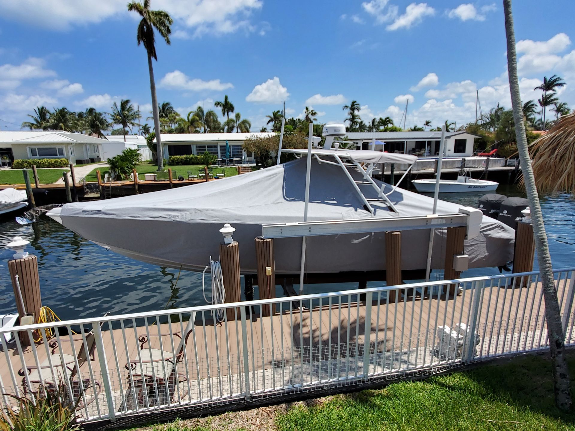 A boat is docked at a dock with a fence around it