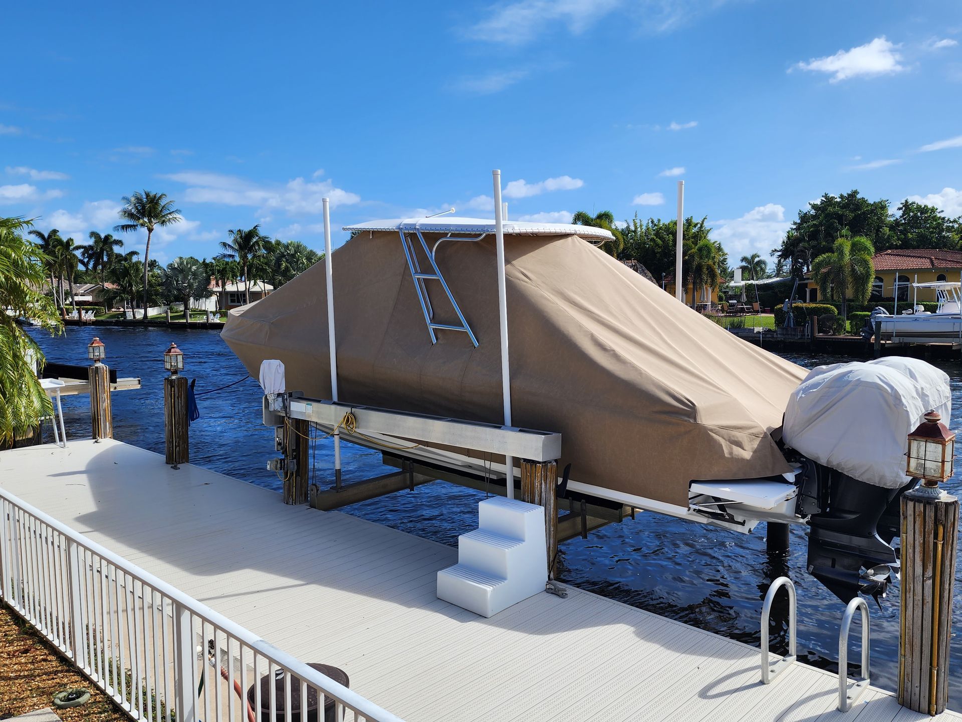 A boat is sitting on a dock with stairs leading up to it.