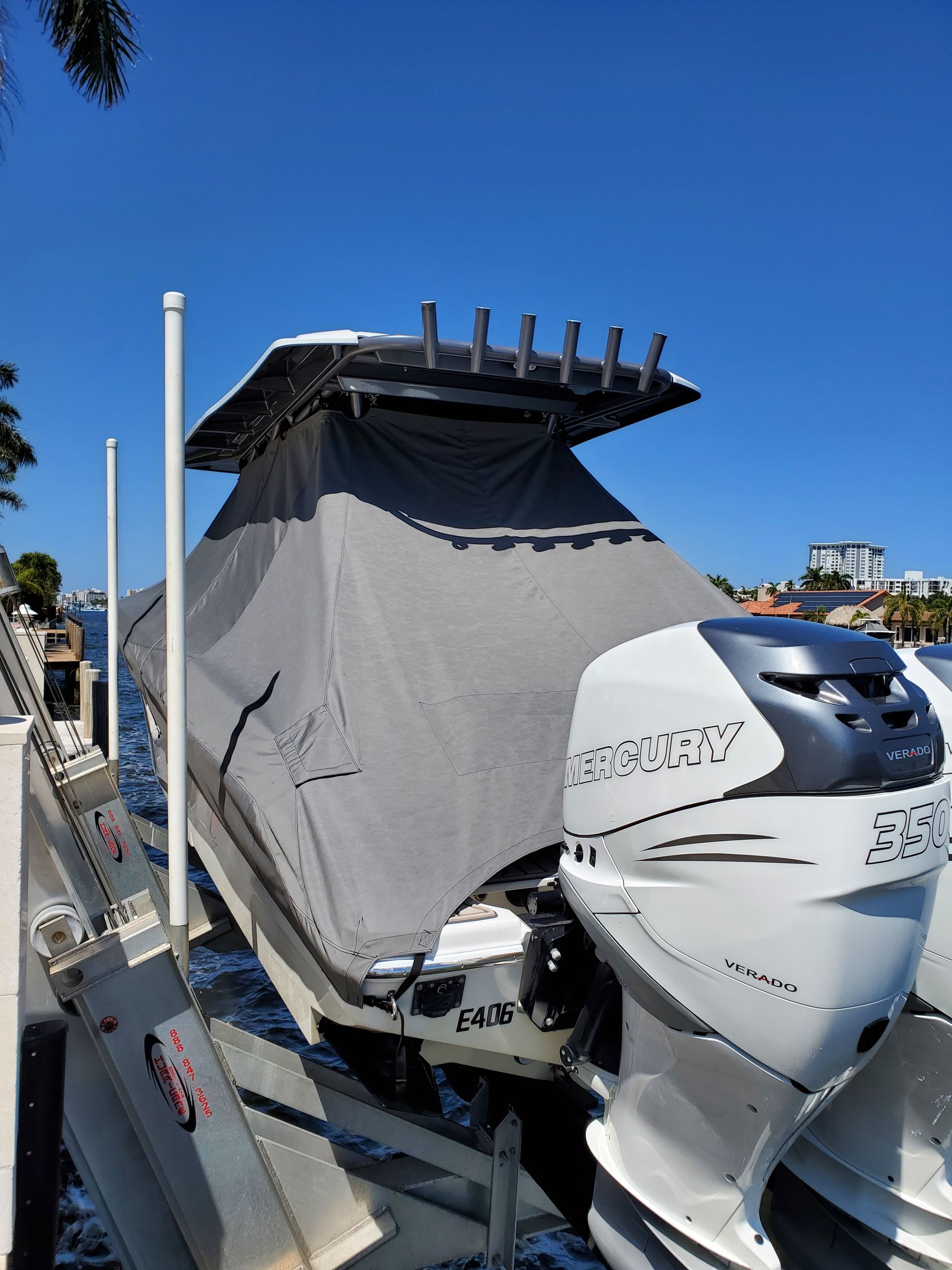 A boat is sitting on a lift in the water.
