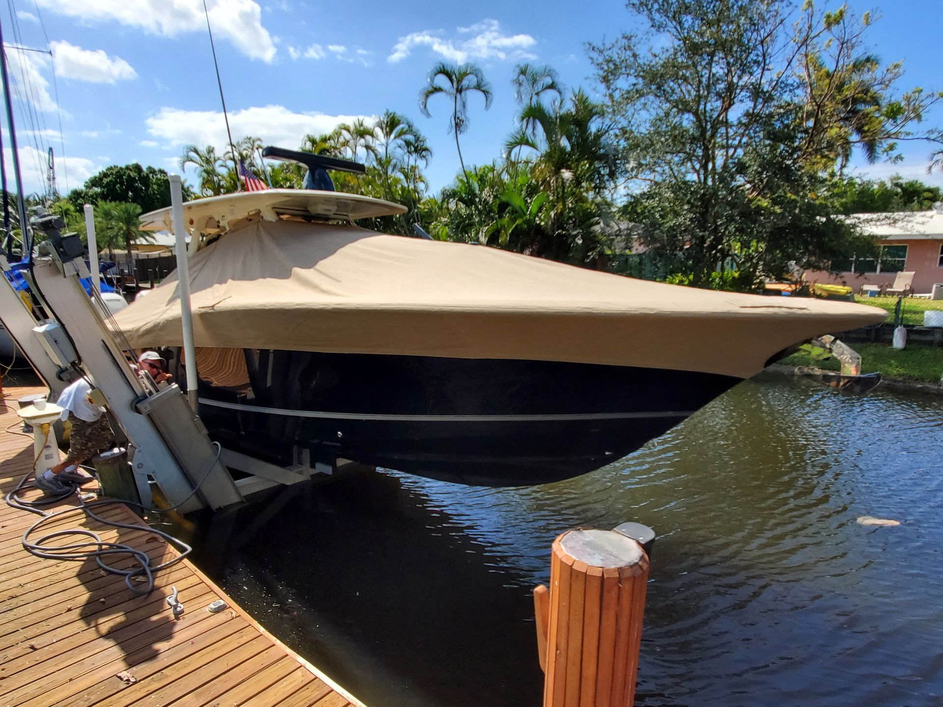 A boat is sitting on a dock next to a body of water