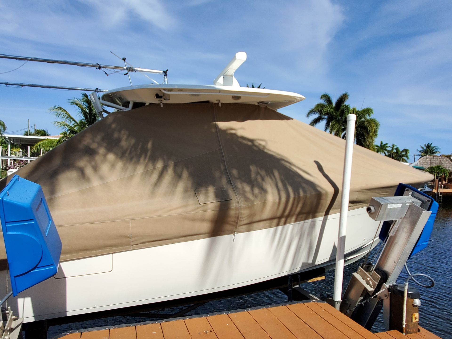 A boat is docked at a dock with a cover on it.
