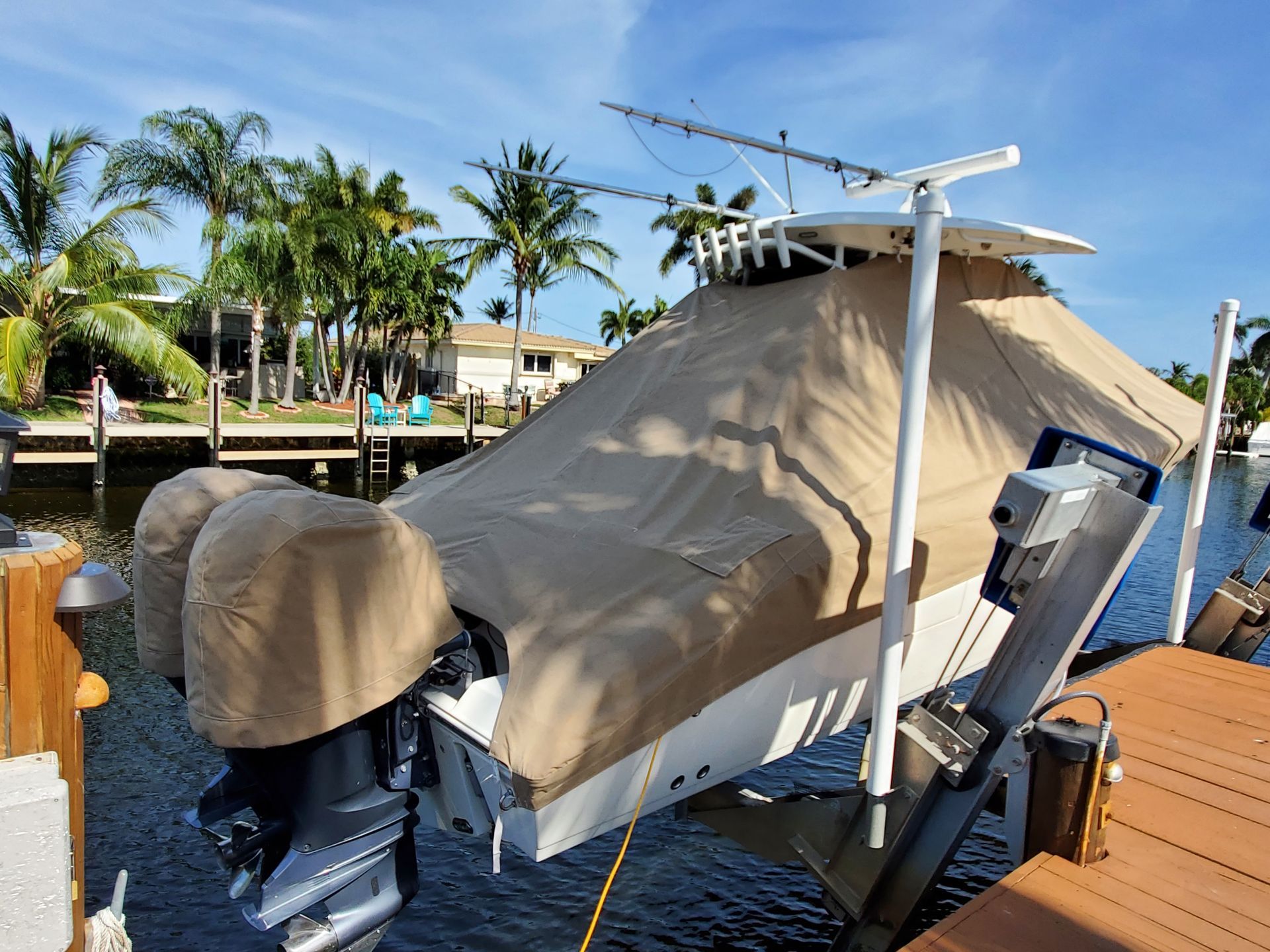 A boat is sitting on a dock with a cover on it.
