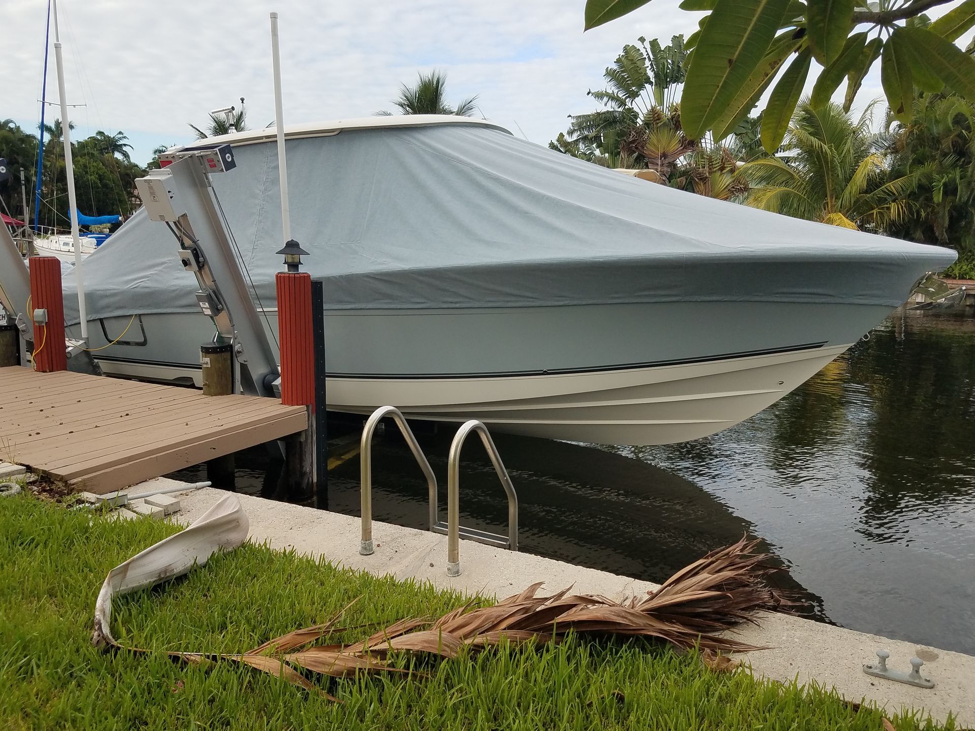 A boat is docked at a dock next to a body of water