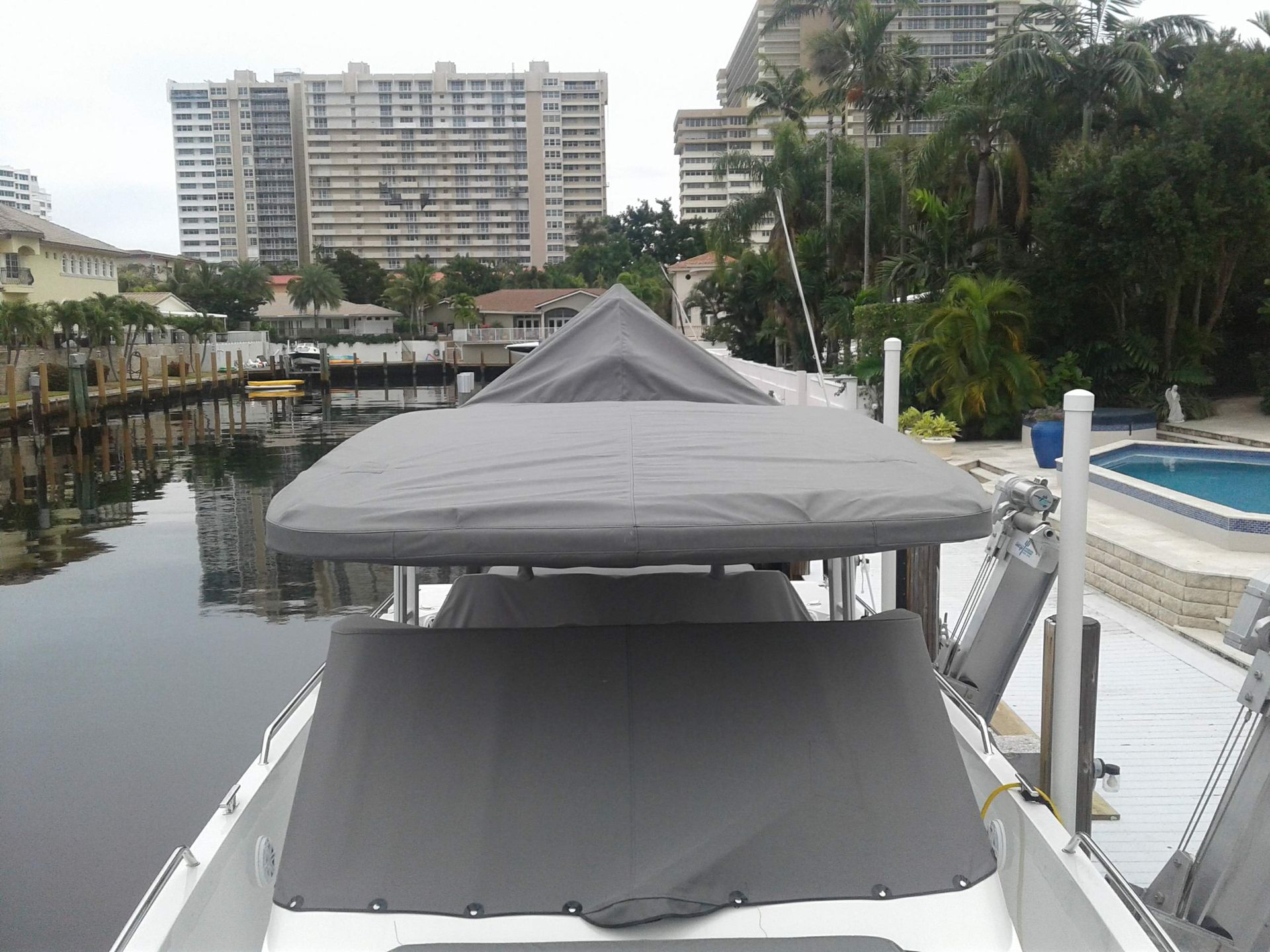 A boat with a gray canopy on top of it