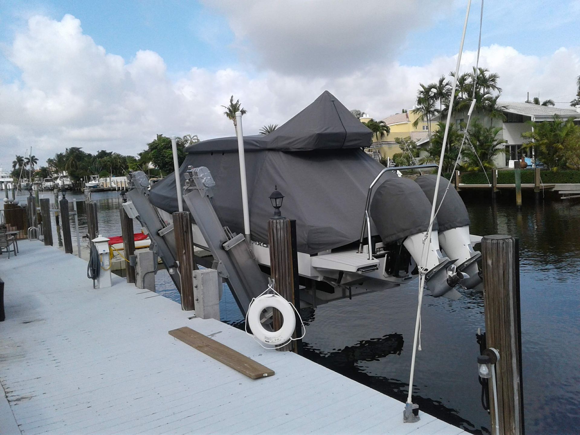 A boat is docked at a dock with a life preserver attached to it