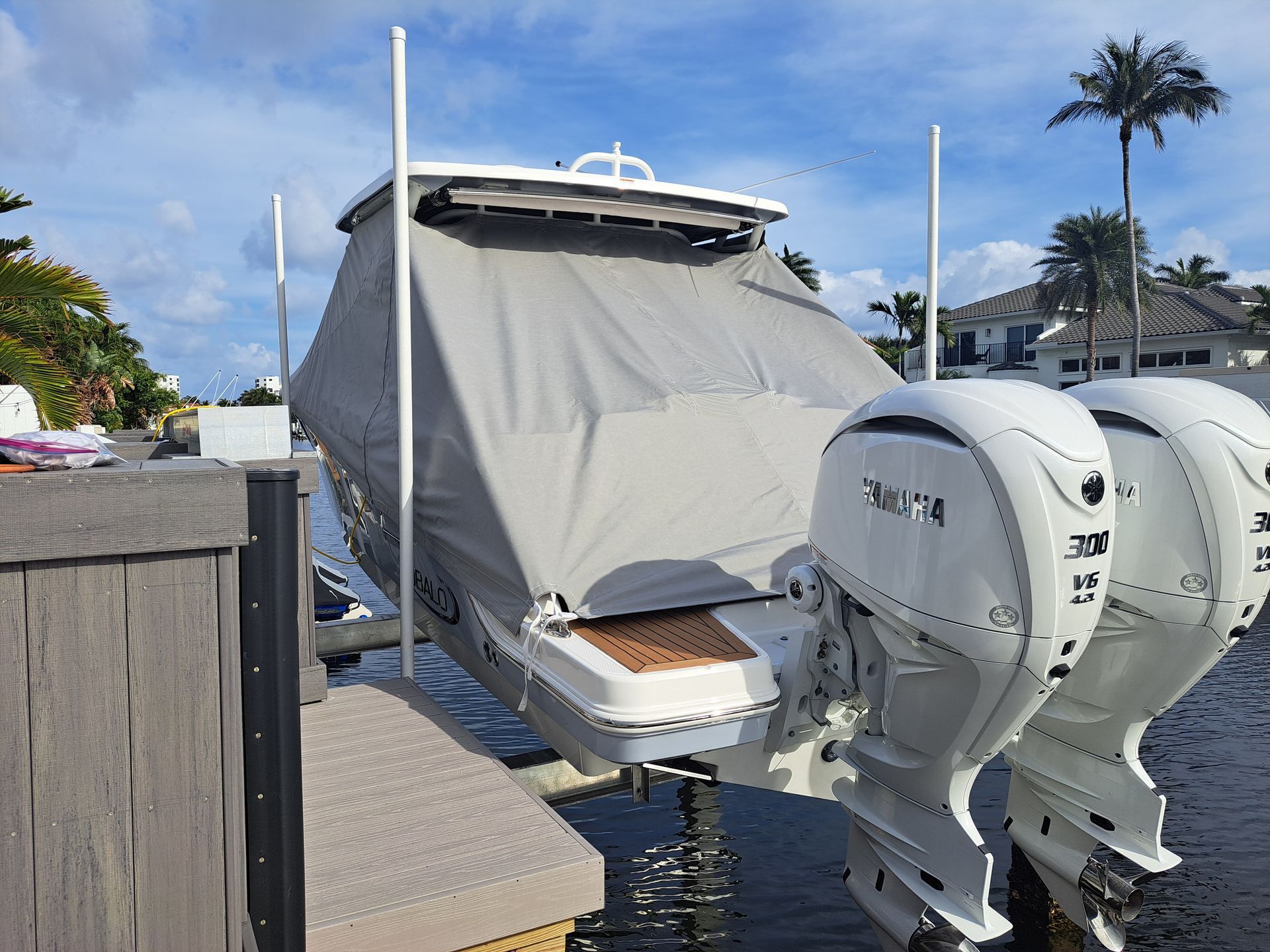 A boat with two engines is docked at a dock.