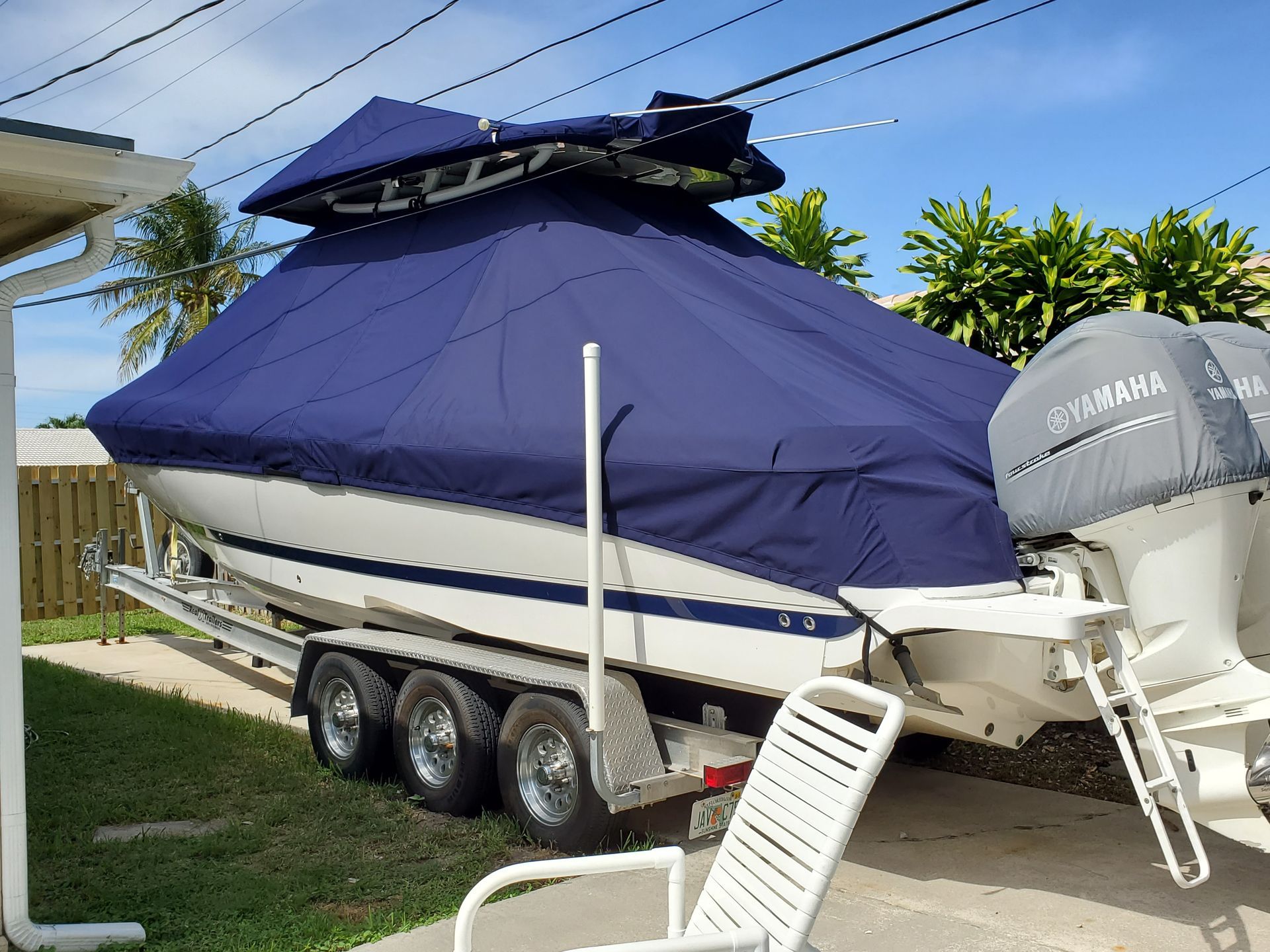 A boat on a trailer with a yamaha engine