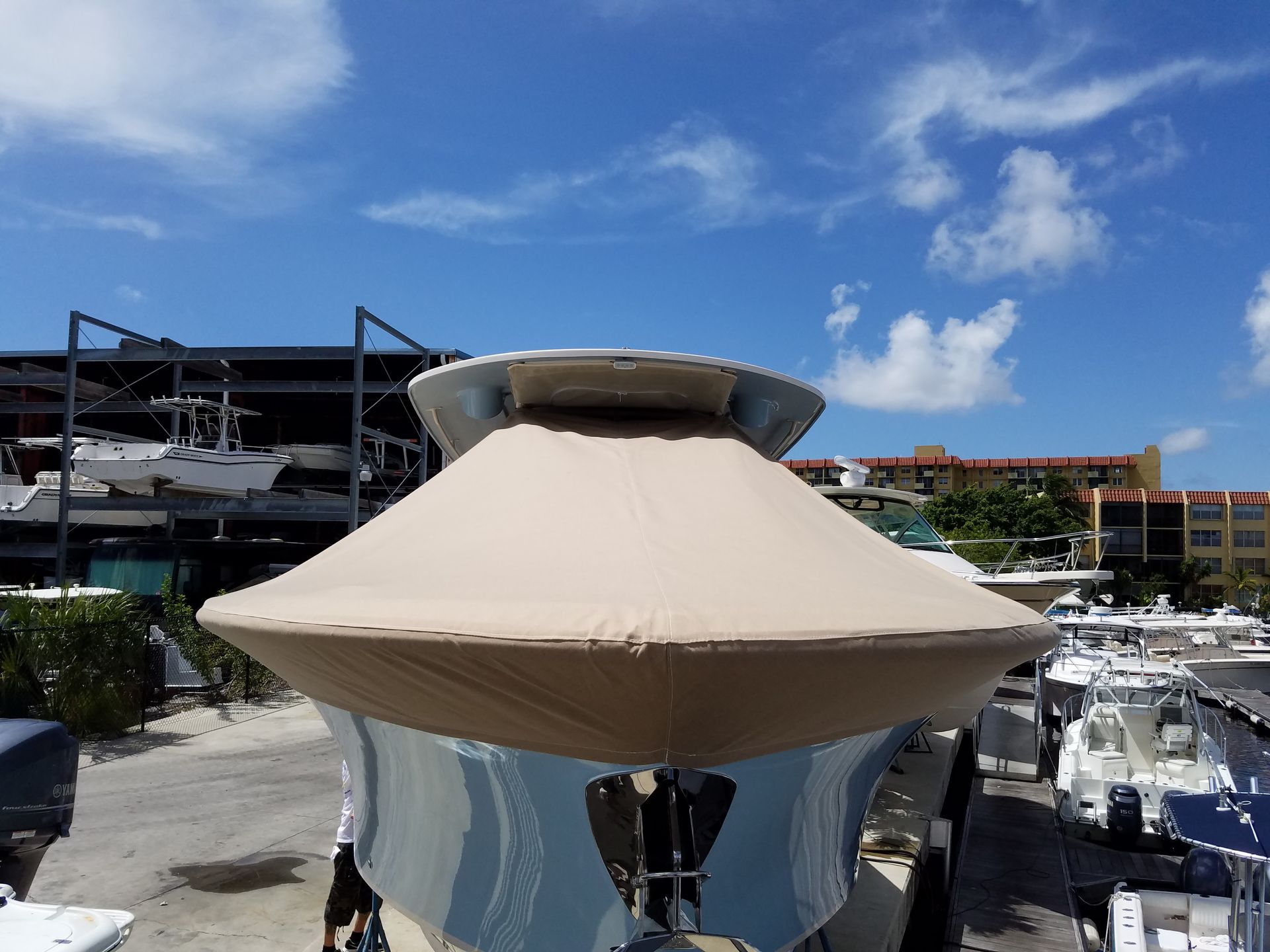 A boat is parked in a marina with boats in the background