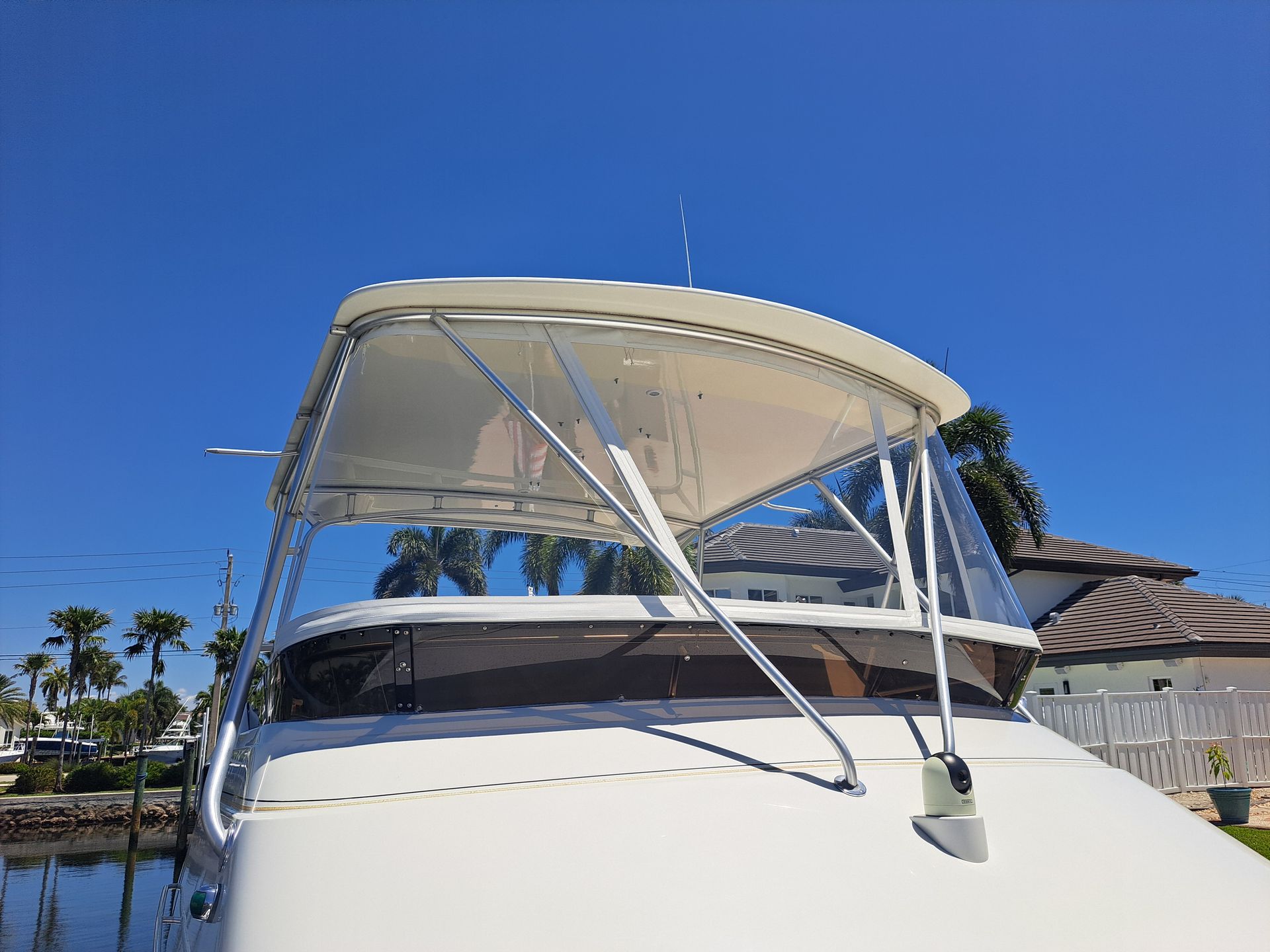 A white boat with a canopy on the top of it.
