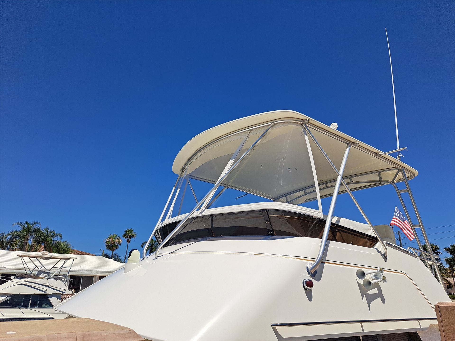 A white boat with a canopy on top of it